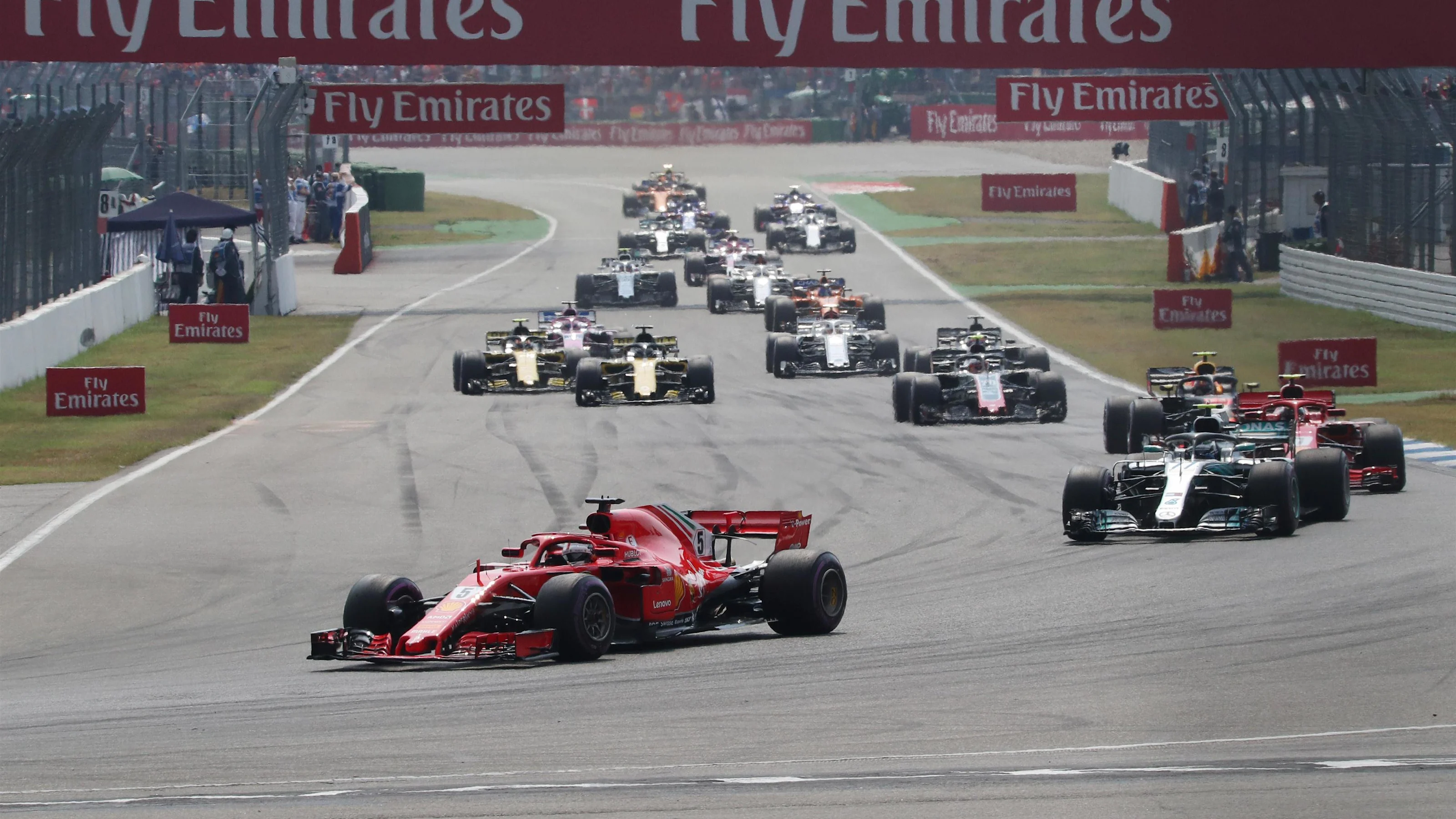 Sebastian Vettel (GER) Ferrari SF-71H leads on lap one action at Formula One World Championship,