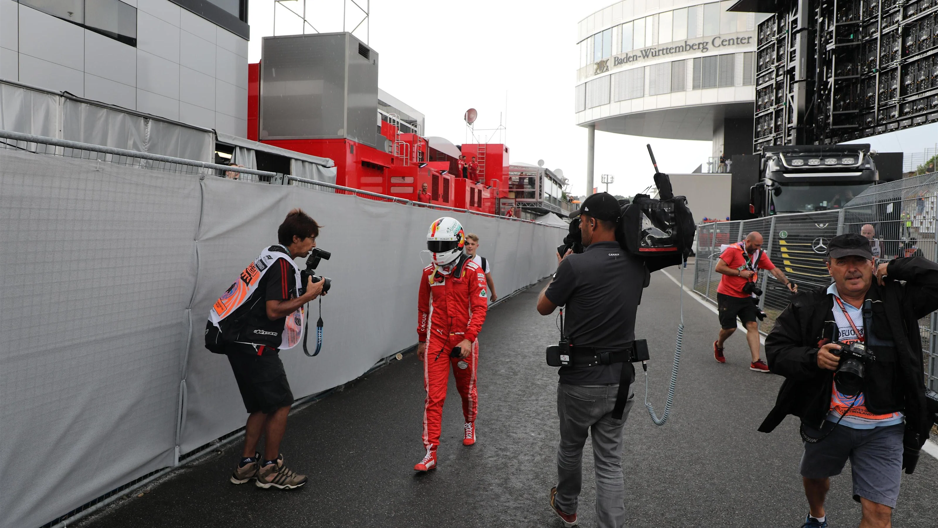 Sebastian Vettel (GER) Ferrari walks in after crashing out of the lead of the race at Formula One