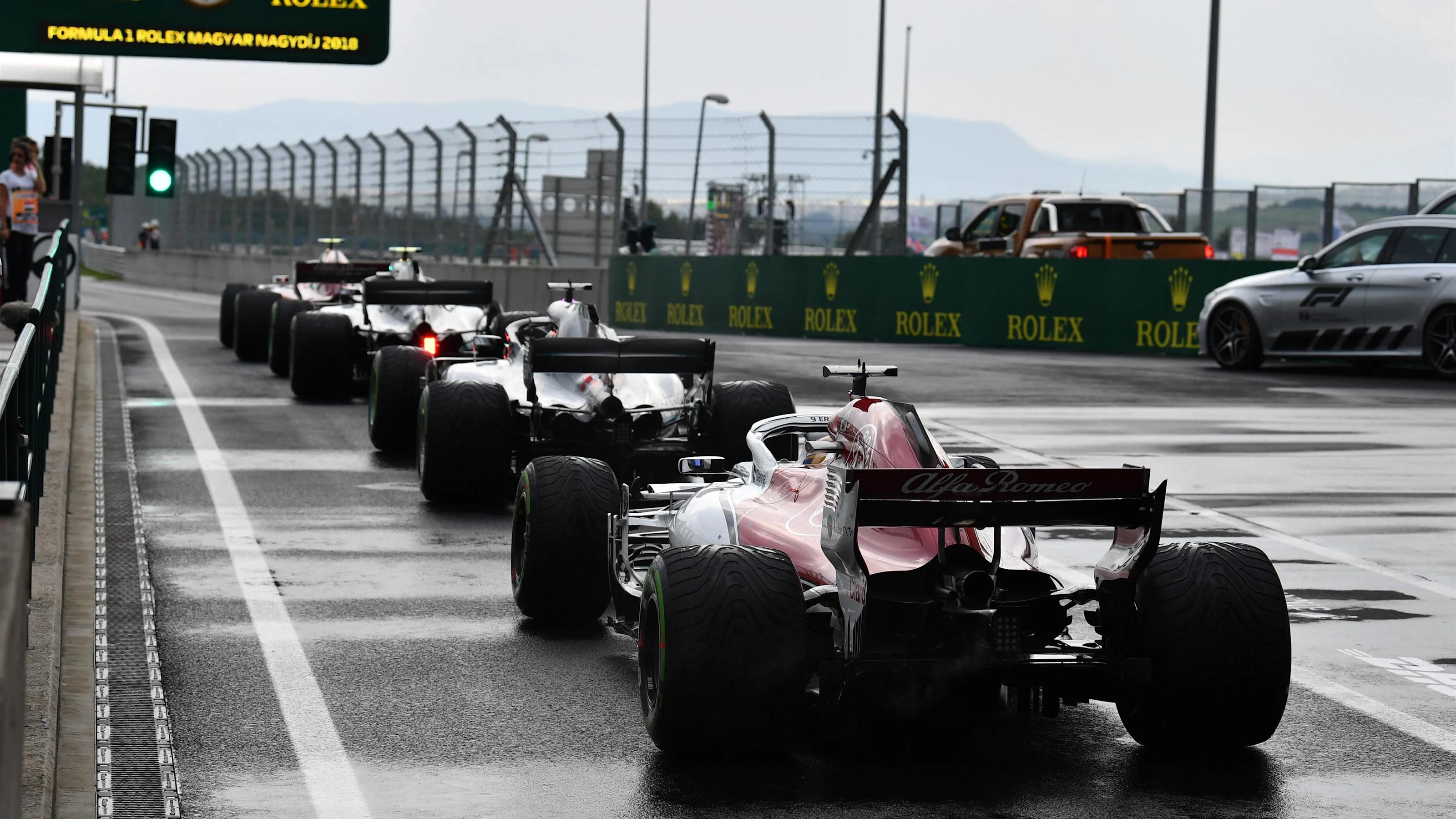 Cars queue in pit lane at Formula One World Championship, Rd12, Hungarian Grand Prix, Qualifying,