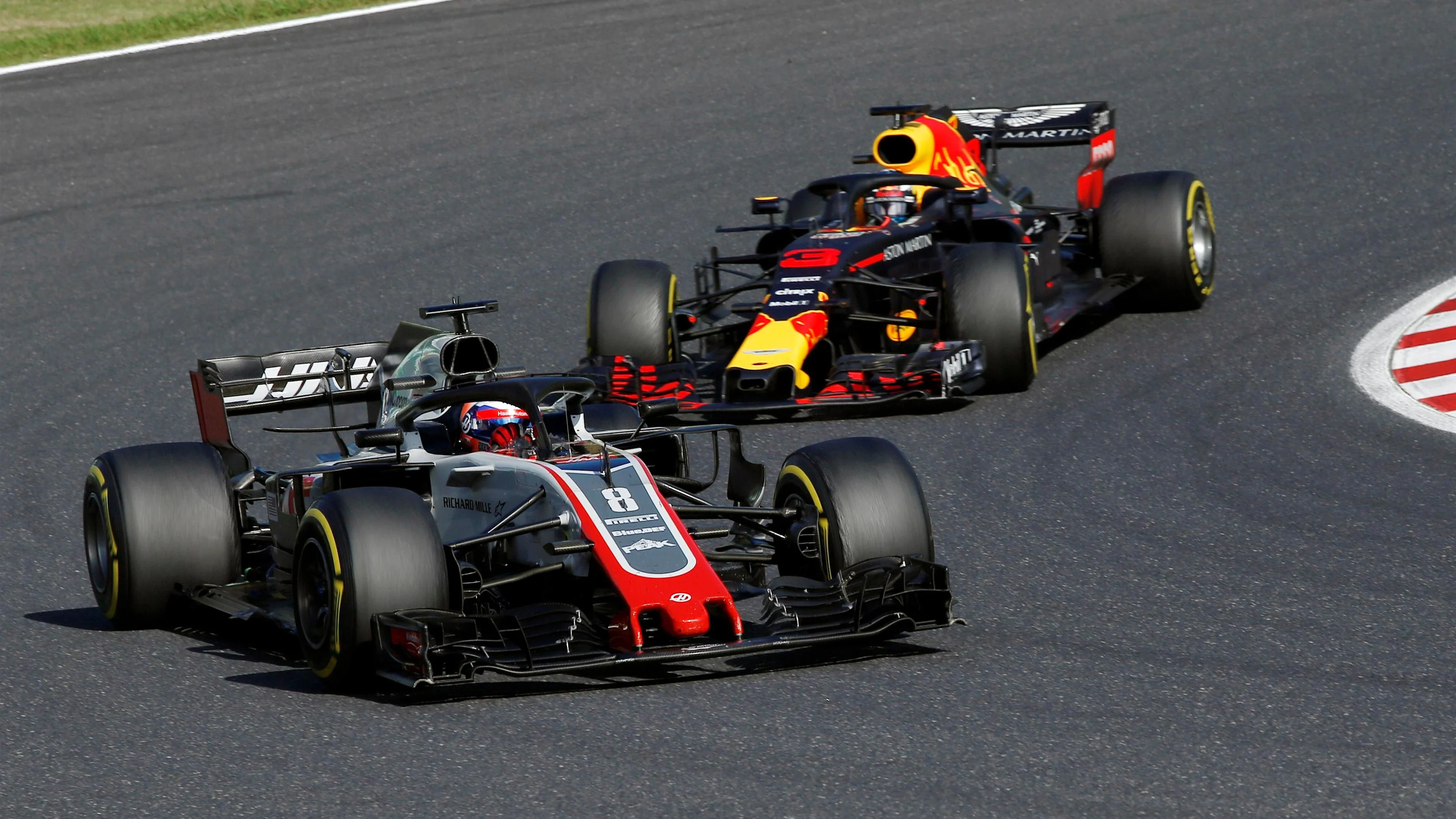Romain Grosjean, Haas F1 Team VF-18 leads Daniel Ricciardo, Red Bull Racing RB14 at Formula One