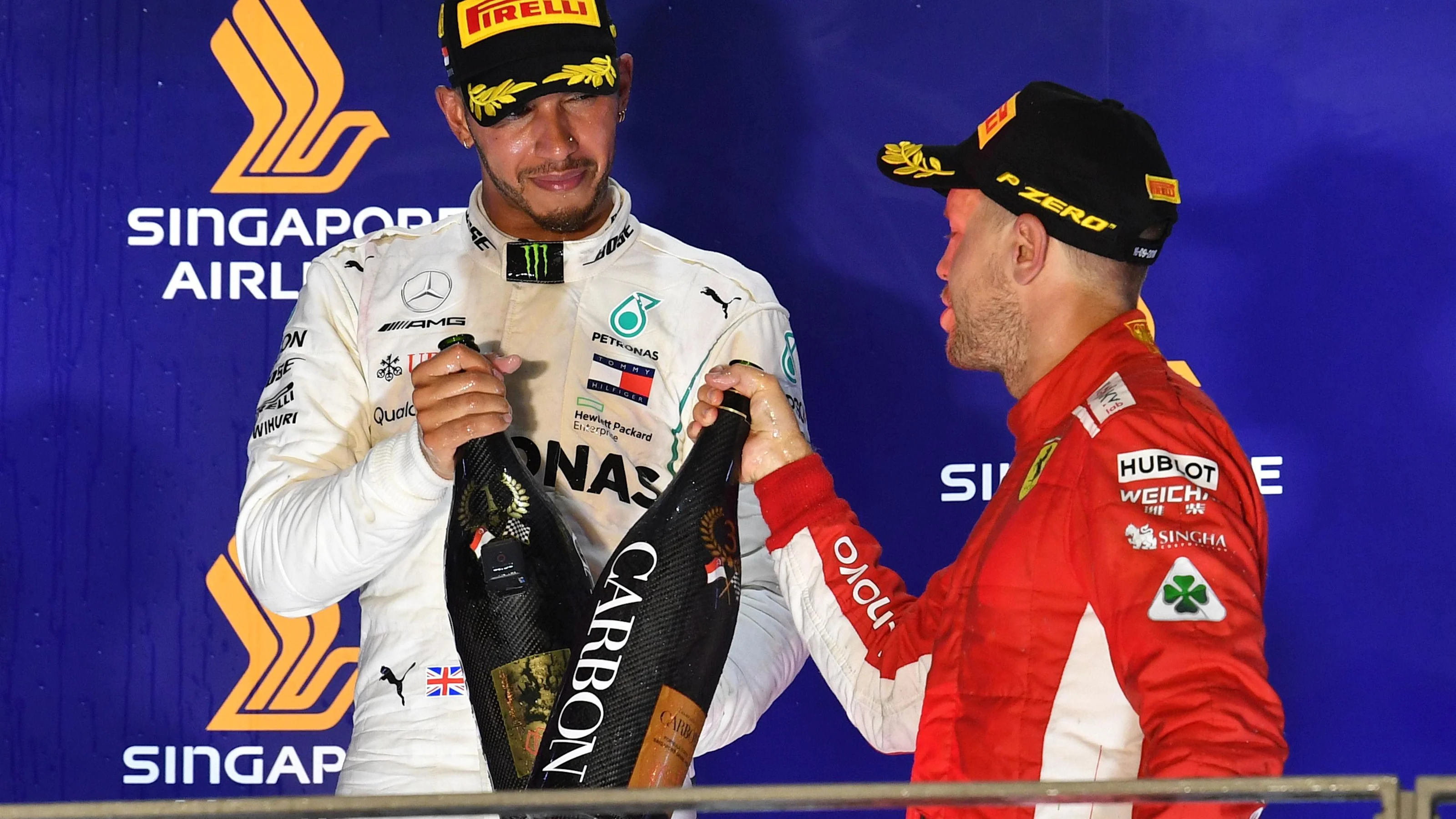 Lewis Hamilton, Mercedes AMG F1 and Sebastian Vettel, Ferrari celebrate on the podium with the