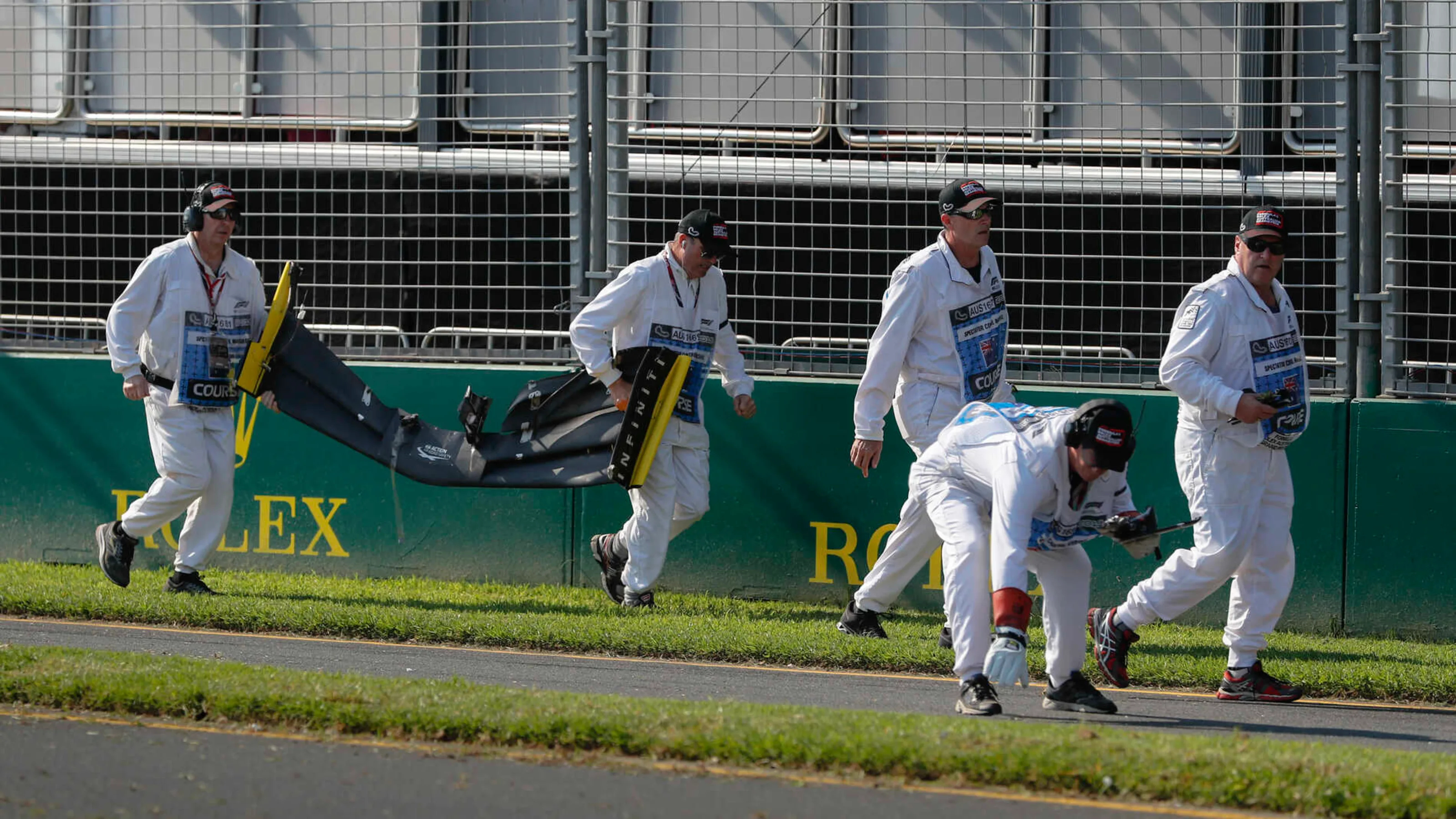 MELBOURNE GRAND PRIX CIRCUIT, AUSTRALIA - MARCH 17: Marshals remove the front wing and debris