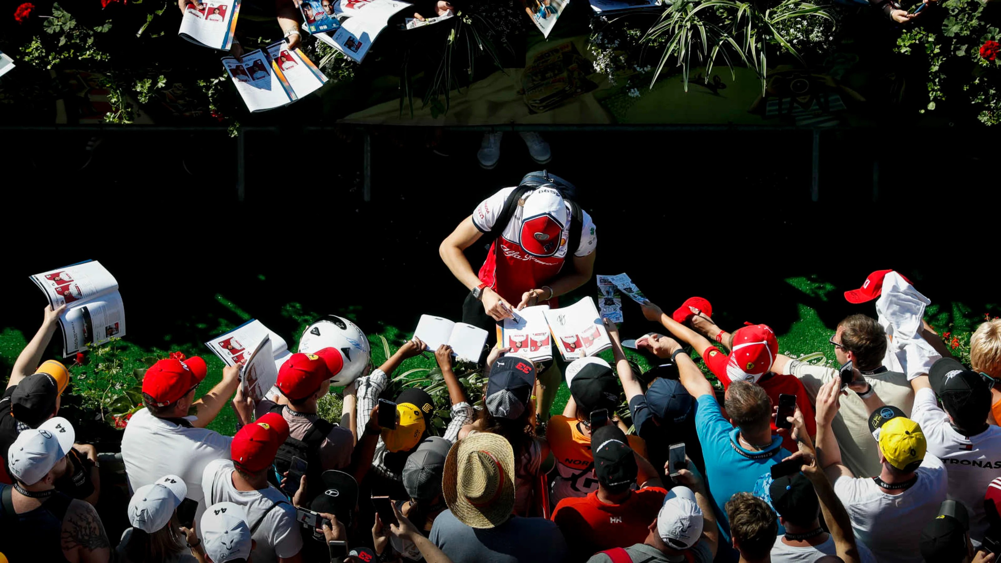 RED BULL RING, AUSTRIA - JUNE 29: Antonio Giovinazzi, Alfa Romeo Racing signs a autograph for a fan