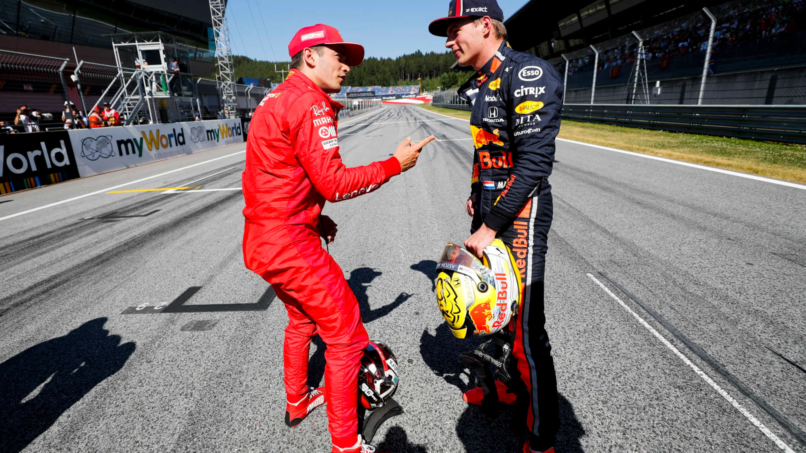 RED BULL RING, AUSTRIA - JUNE 29: Pole man Charles Leclerc, Ferrari, talks with Max Verstappen, Red