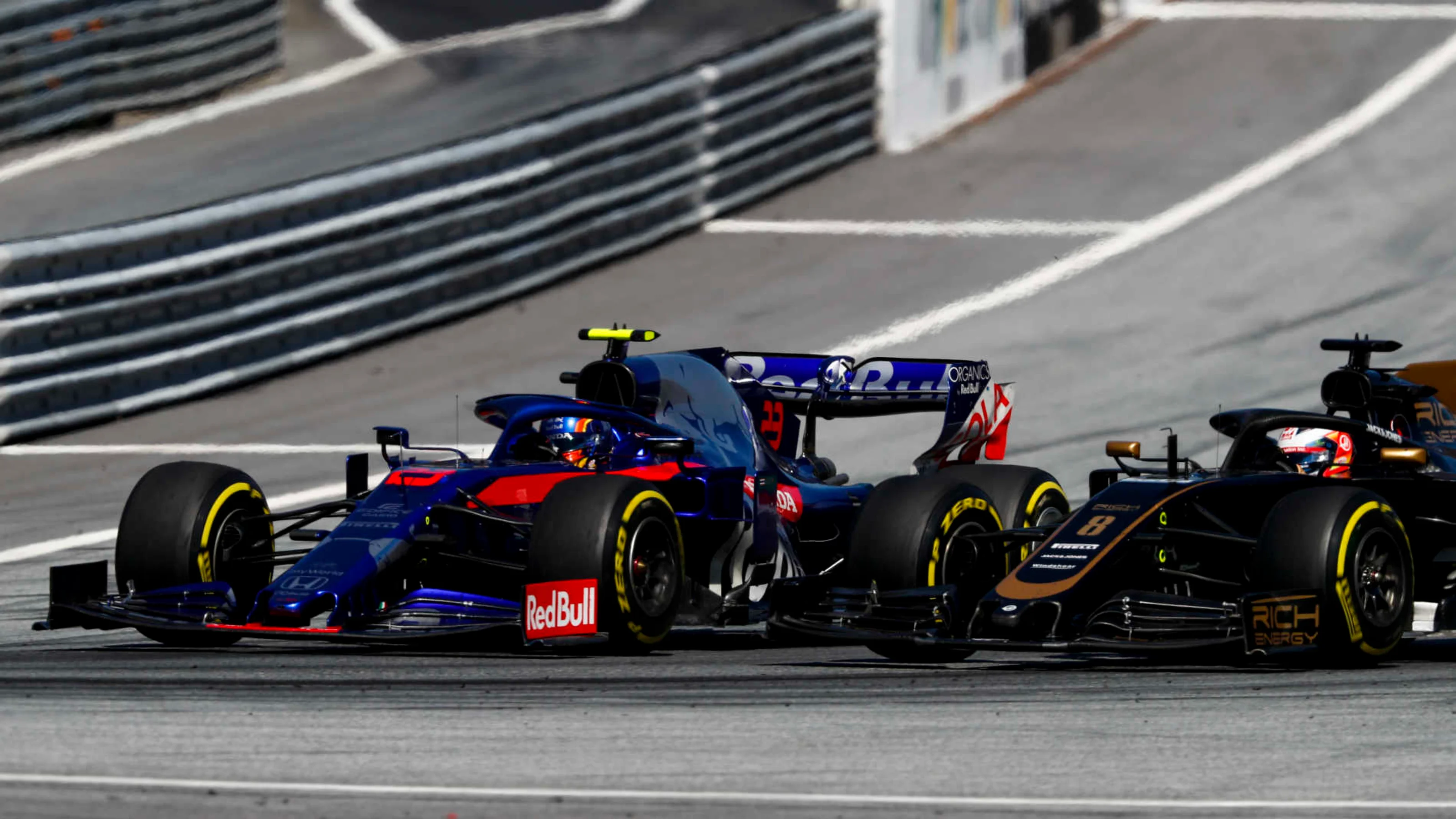RED BULL RING, AUSTRIA - JUNE 30: Alexander Albon, Toro Rosso STR14, battles with Romain Grosjean,