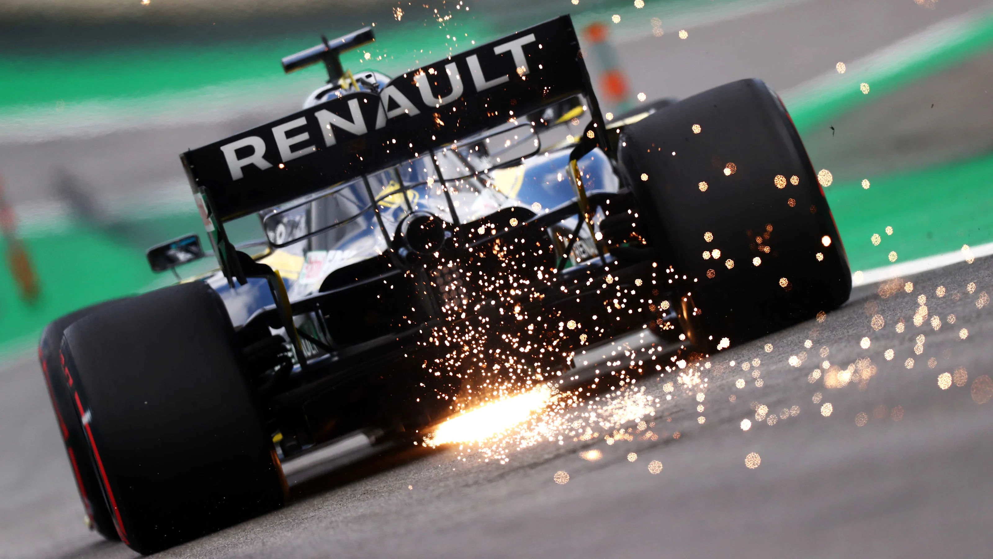 SAO PAULO, BRAZIL - NOVEMBER 16: Sparks fly behind Daniel Ricciardo of Australia driving the (3)