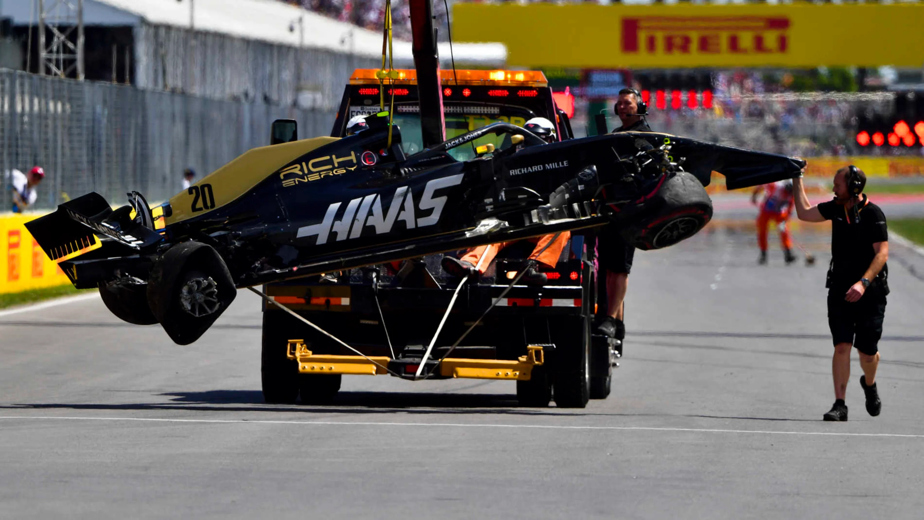 CIRCUIT GILLES-VILLENEUVE, CANADA - JUNE 08: Marshals remove the damaged car of Kevin Magnussen,