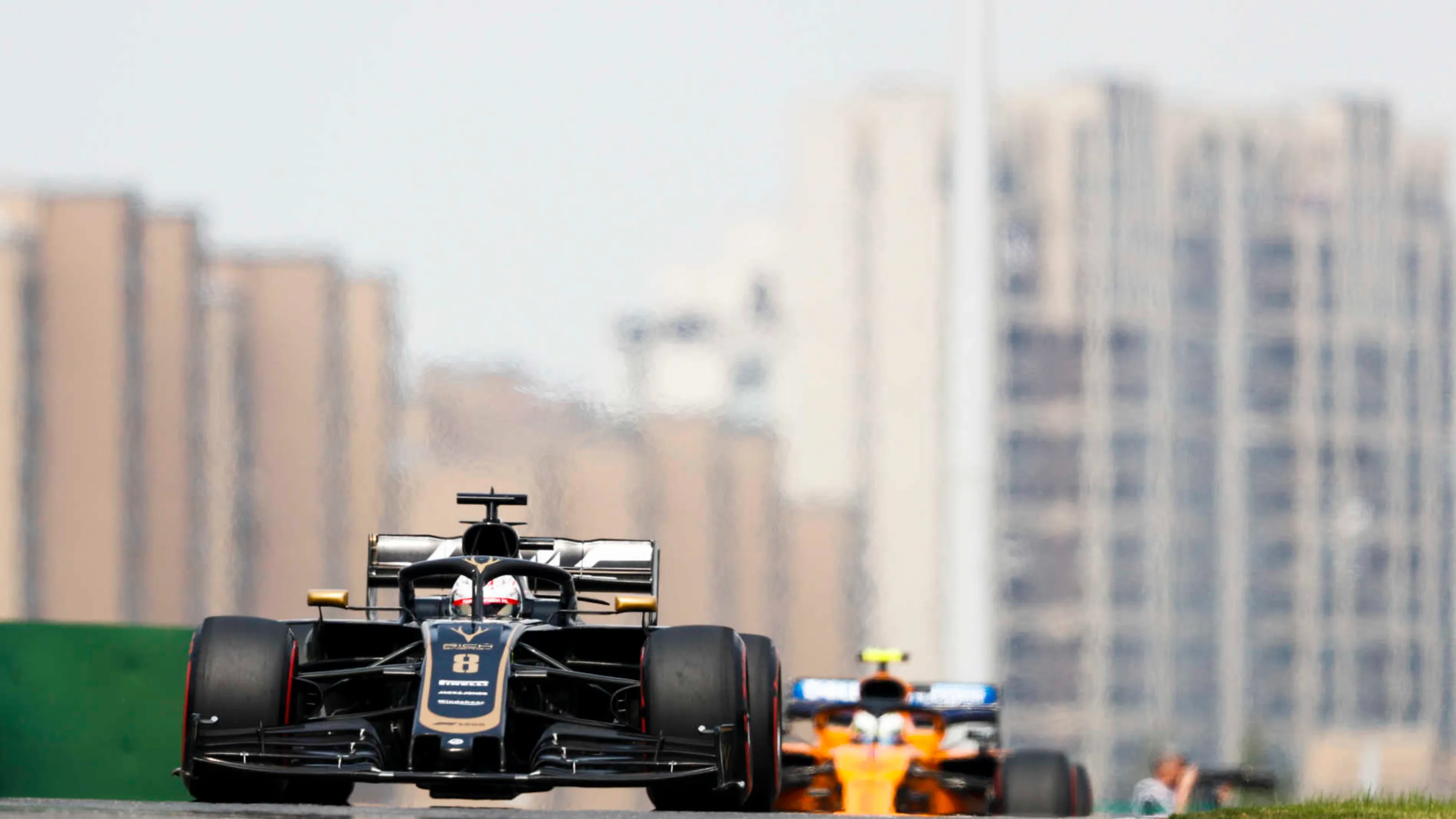 SHANGHAI INTERNATIONAL CIRCUIT, CHINA - APRIL 13: Romain Grosjean, Haas VF-19, leads Lando Norris,