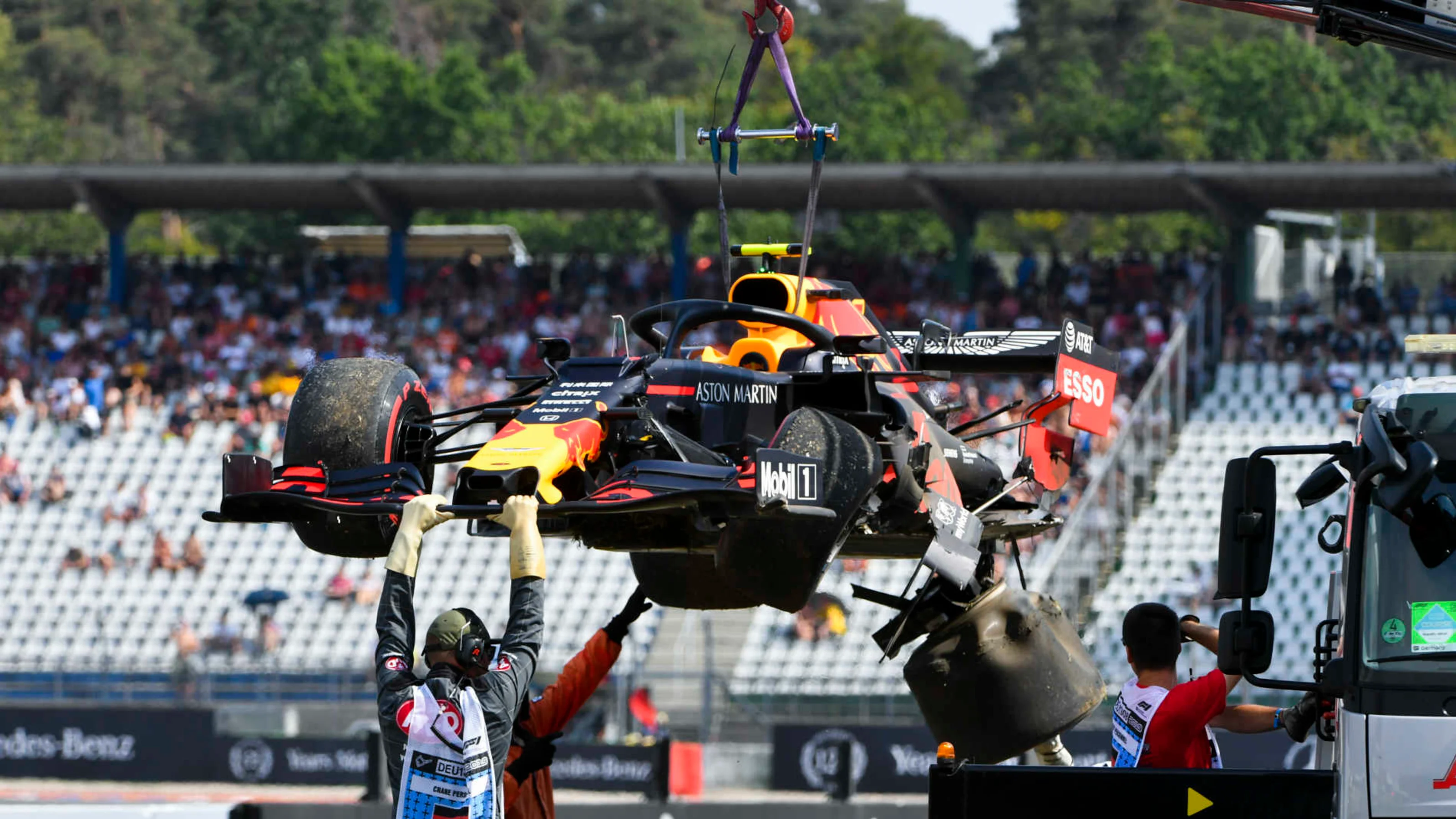 HOCKENHEIMRING, GERMANY - JULY 26: Marshals deal with the damaged car of Pierre Gasly, Red Bull