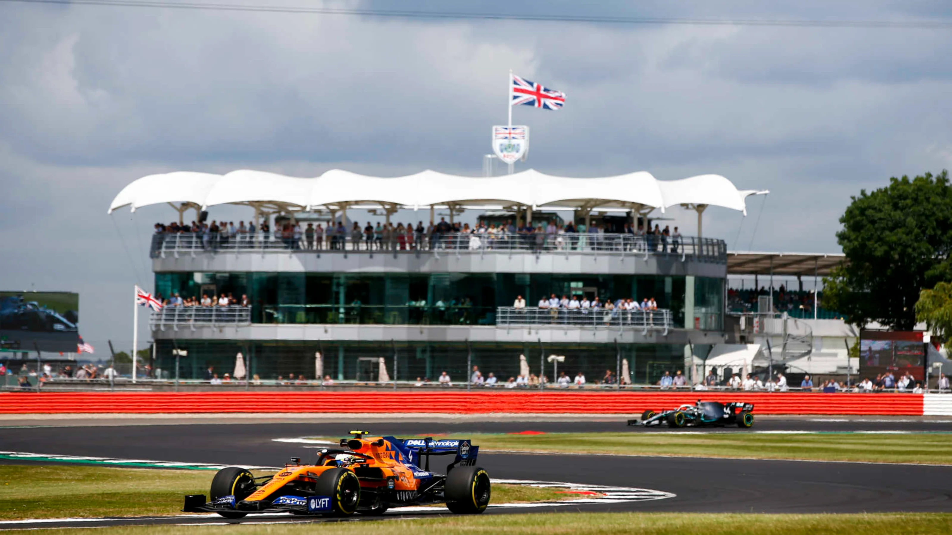 SILVERSTONE, UNITED KINGDOM - JULY 12: Lando Norris, McLaren MCL34, leads Lewis Hamilton, Mercedes