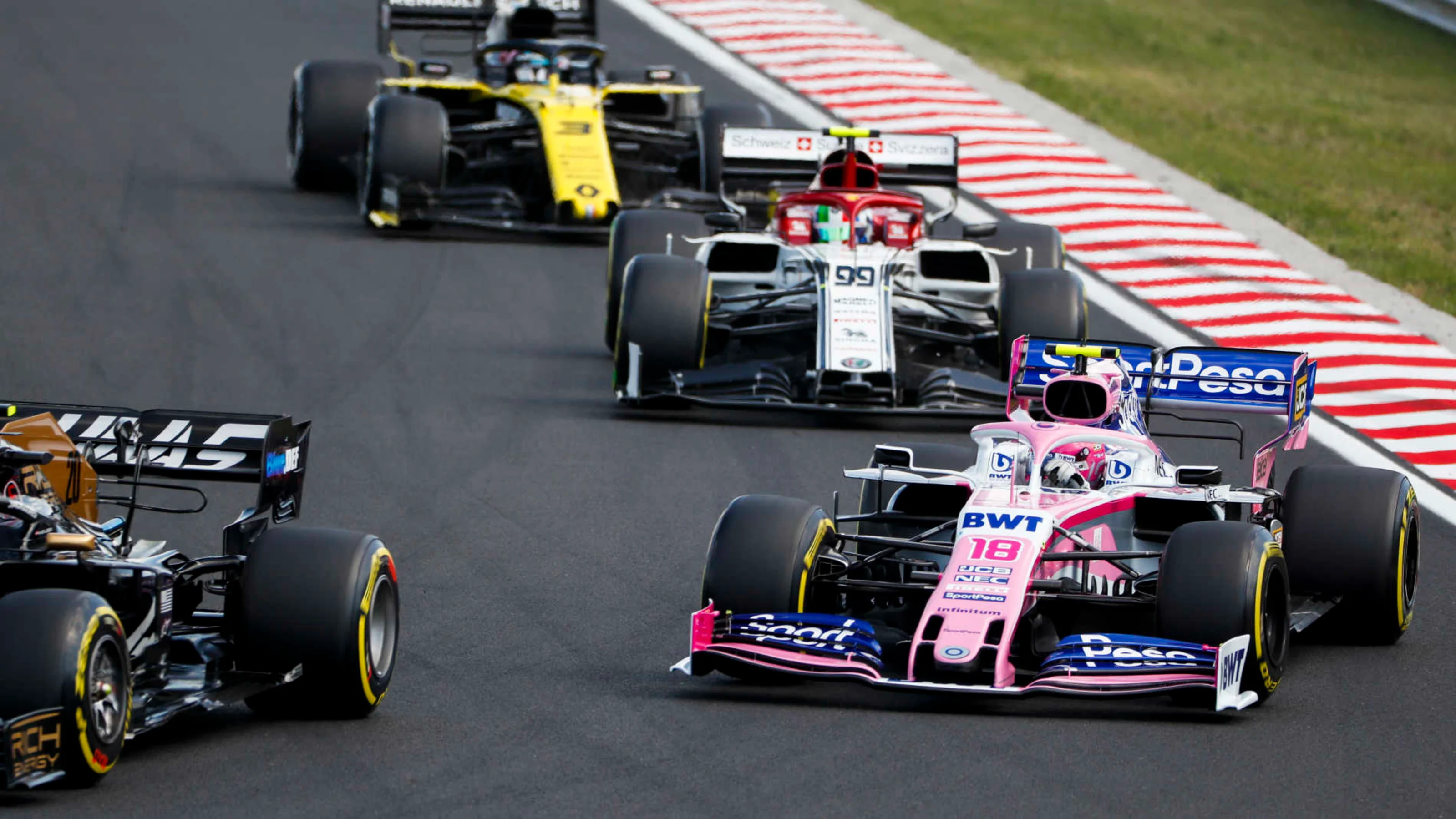 HUNGARORING, HUNGARY - AUGUST 04: Kevin Magnussen, Haas VF-19, leads Lance Stroll, Racing Point