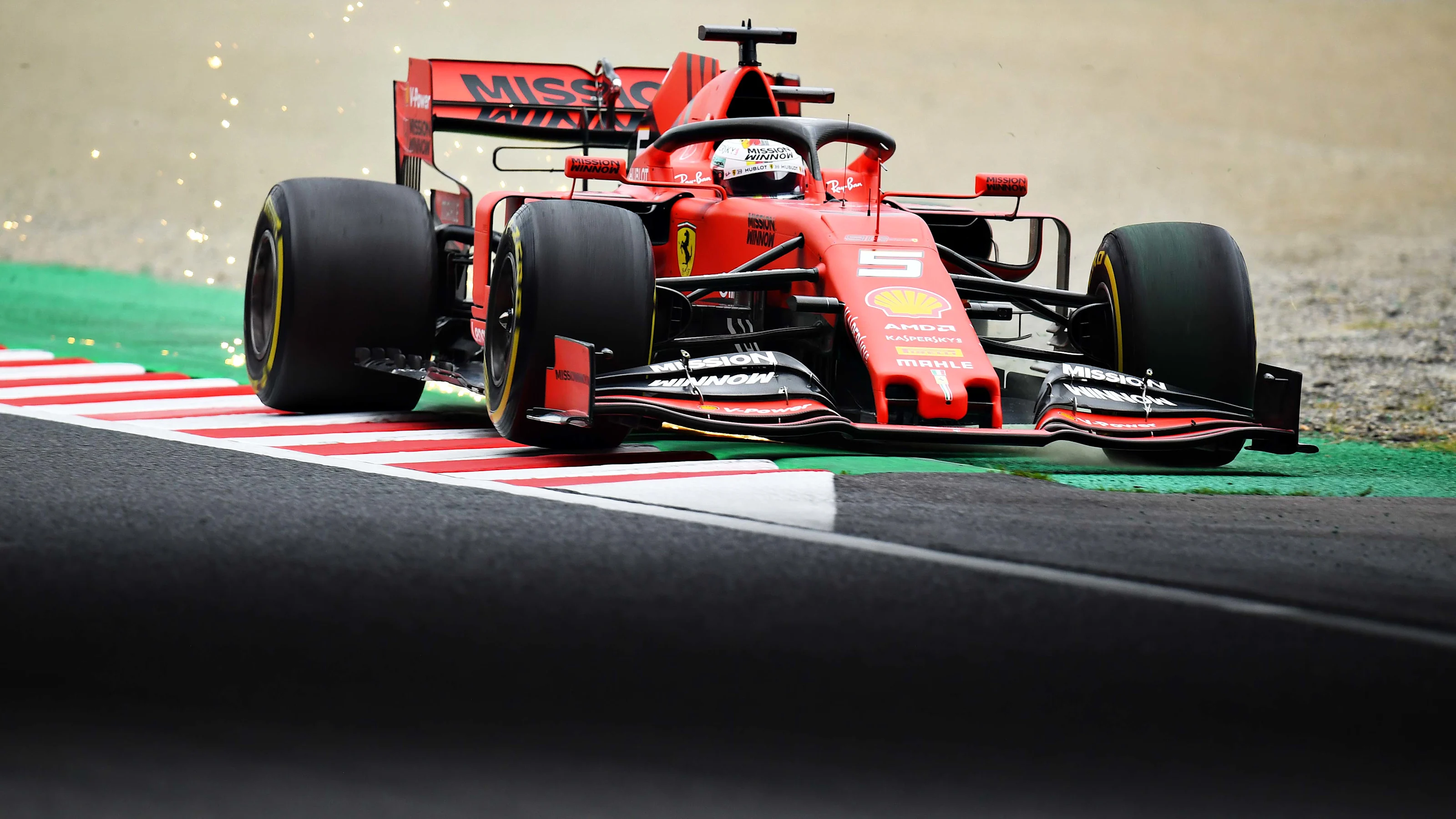 SUZUKA, JAPAN - OCTOBER 11: Sparks fly behind Sebastian Vettel of Germany driving the (5) Scuderia