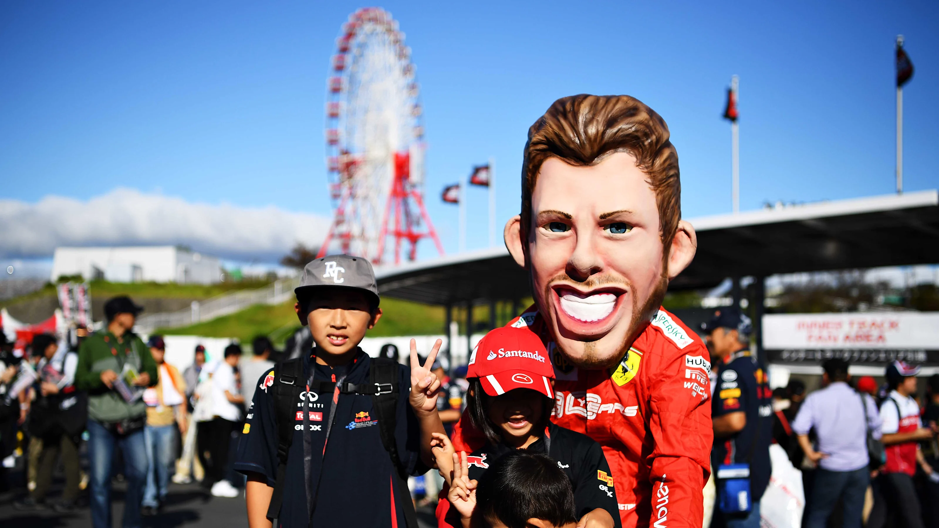 SUZUKA, JAPAN - OCTOBER 13: Red Bull Racing fans and Ferrari fans show their support before