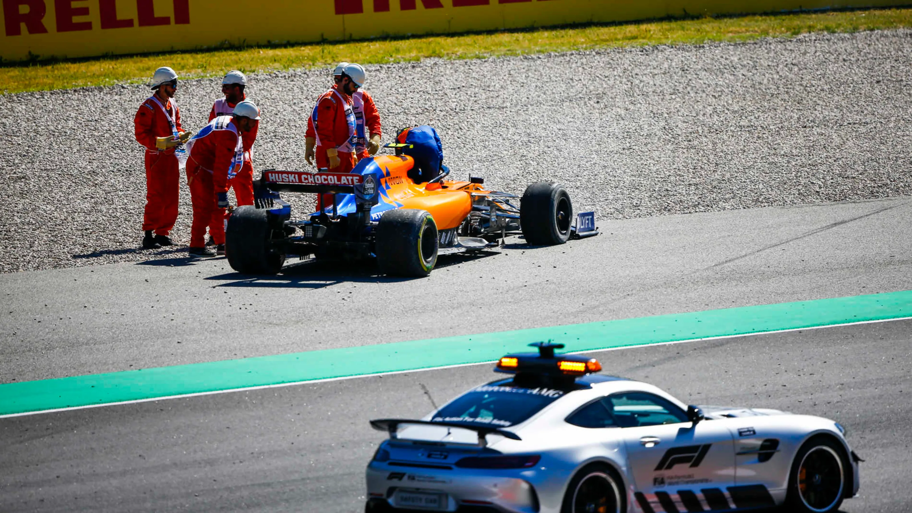 CIRCUIT DE BARCELONA-CATALUNYA, SPAIN - MAY 12: Safety Car drives past the car of Lando Norris,