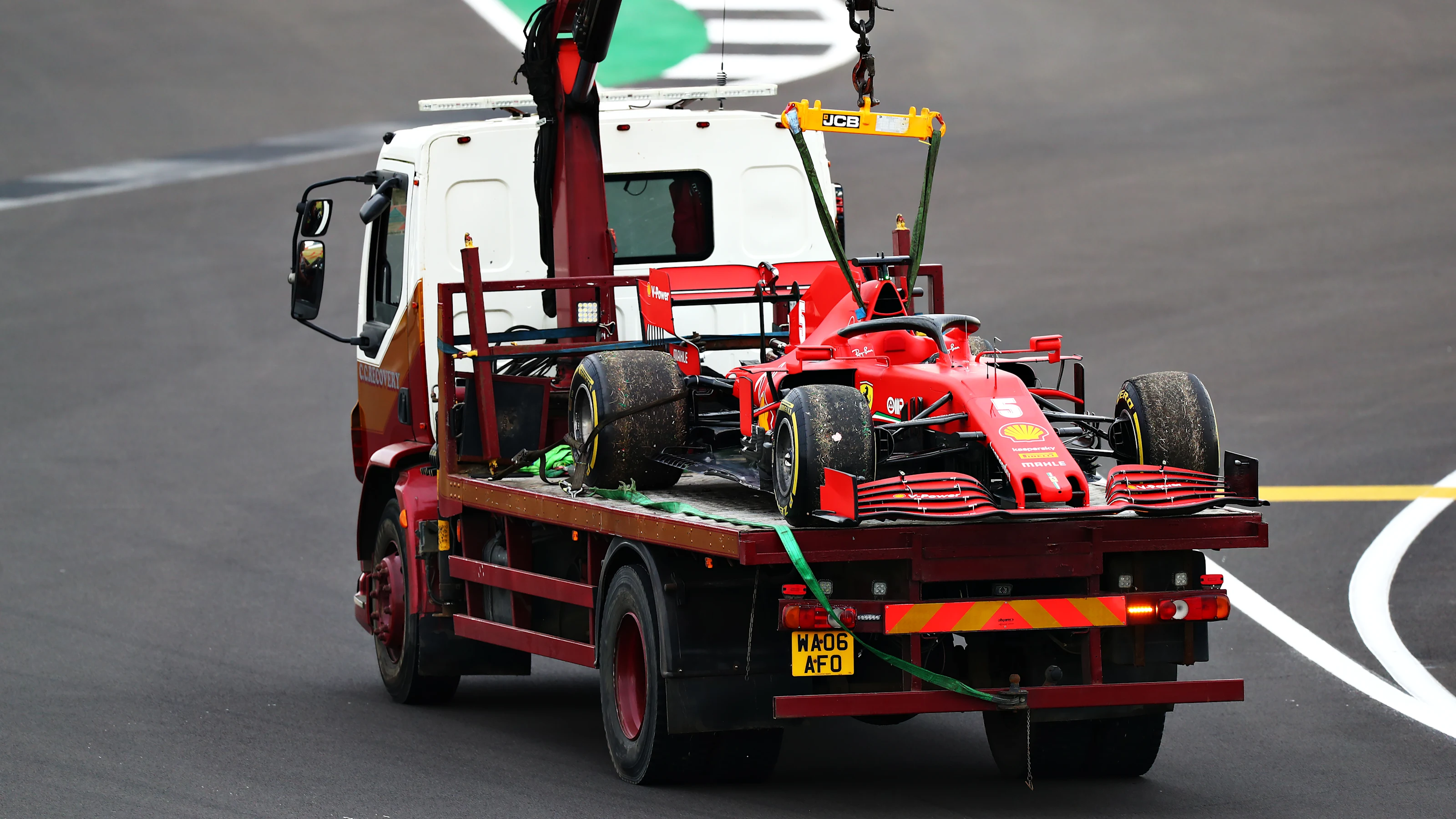 NORTHAMPTON, ENGLAND - AUGUST 07: The broken down car of Sebastian Vettel of Germany and Ferrari is