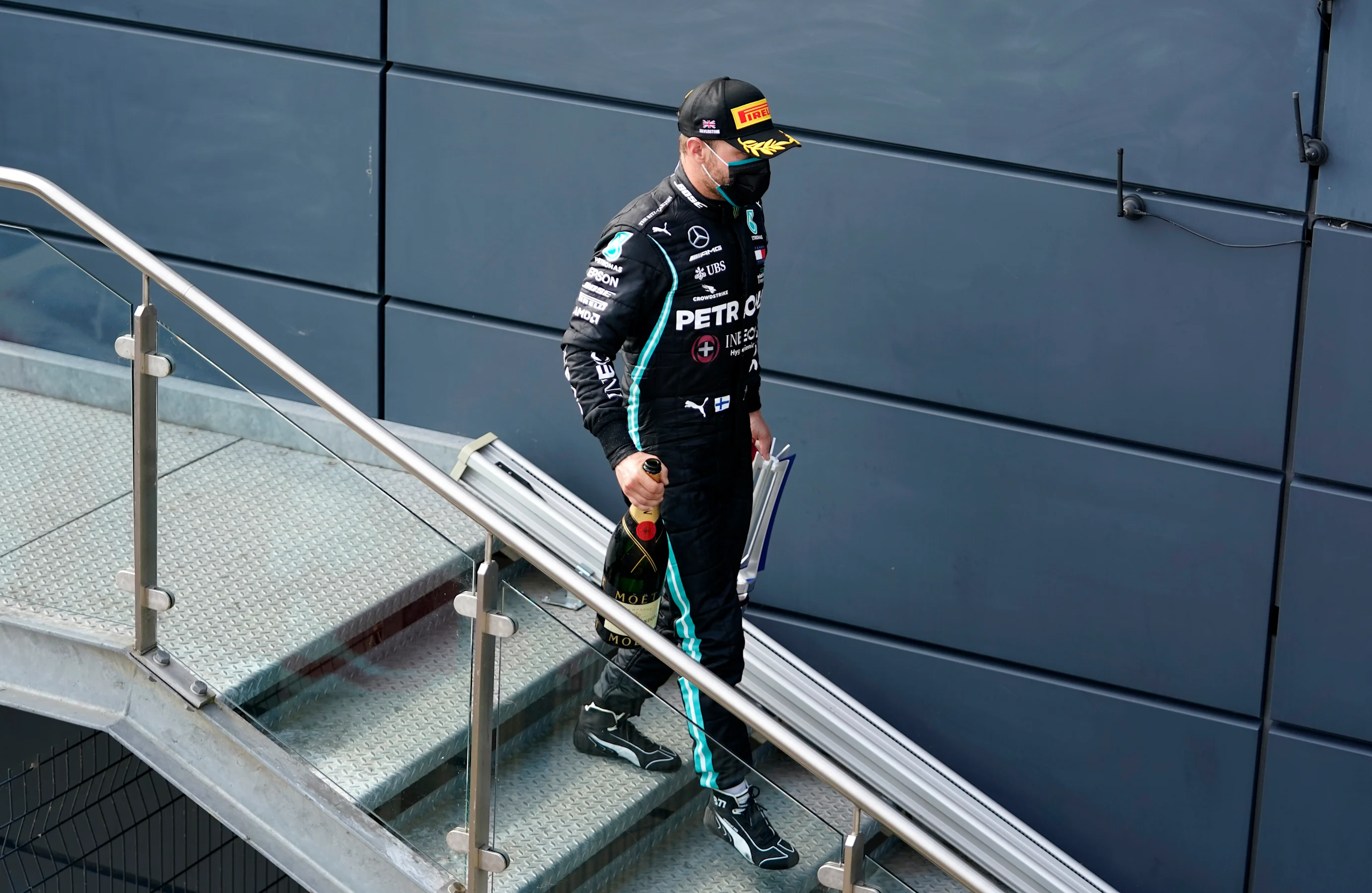 NORTHAMPTON, ENGLAND - AUGUST 09: Third placed Valtteri Bottas of Finland and Mercedes GP walks