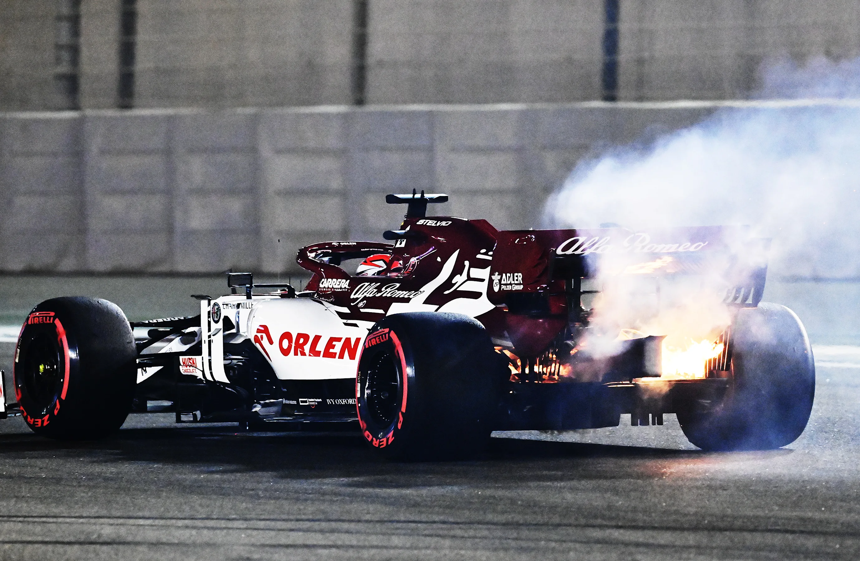 ABU DHABI, UNITED ARAB EMIRATES - DECEMBER 11: Fire emerges from the car of Kimi Raikkonen of