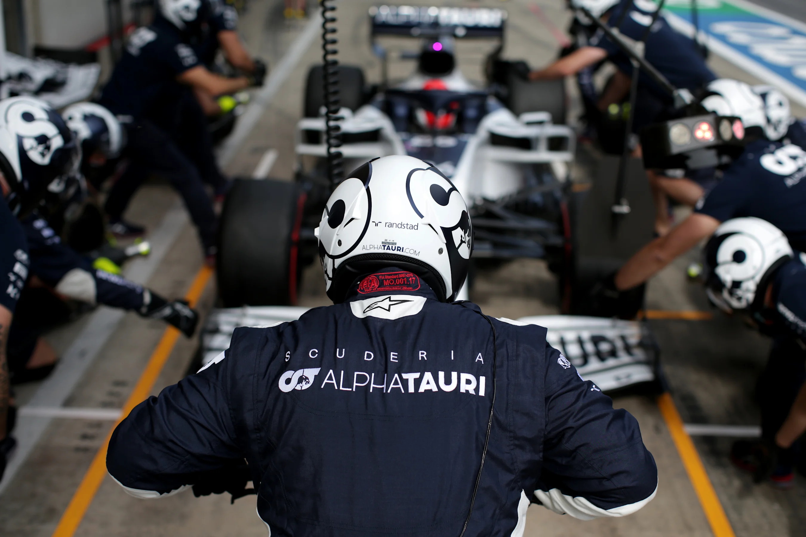 SPIELBERG, AUSTRIA - JULY 03: Scuderia AlphaTauri team members prepare for a pit stop for during