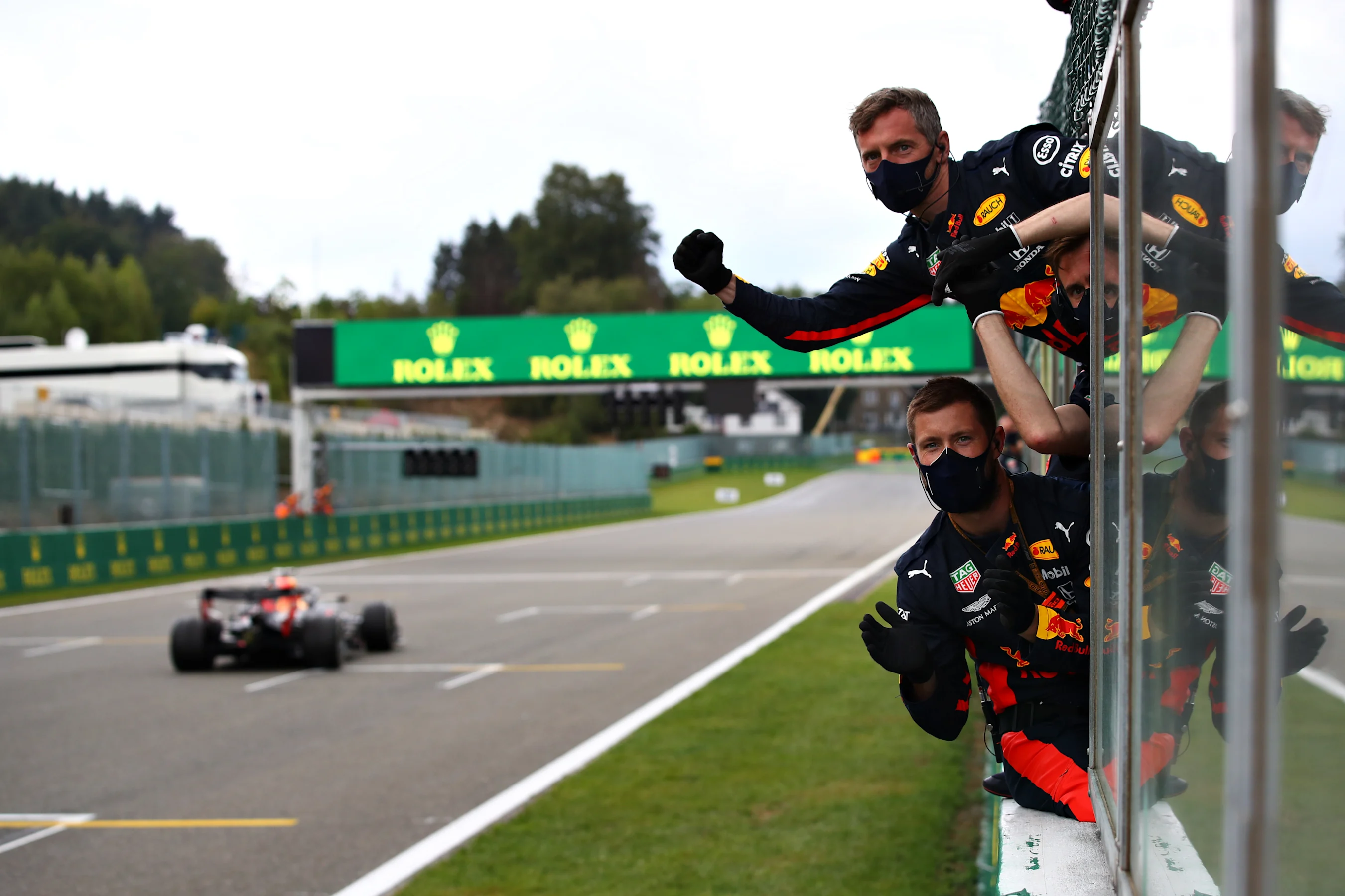 SPA, BELGIUM - AUGUST 30: Red Bull Racing team members celebrate on the pit wall as Max Verstappen