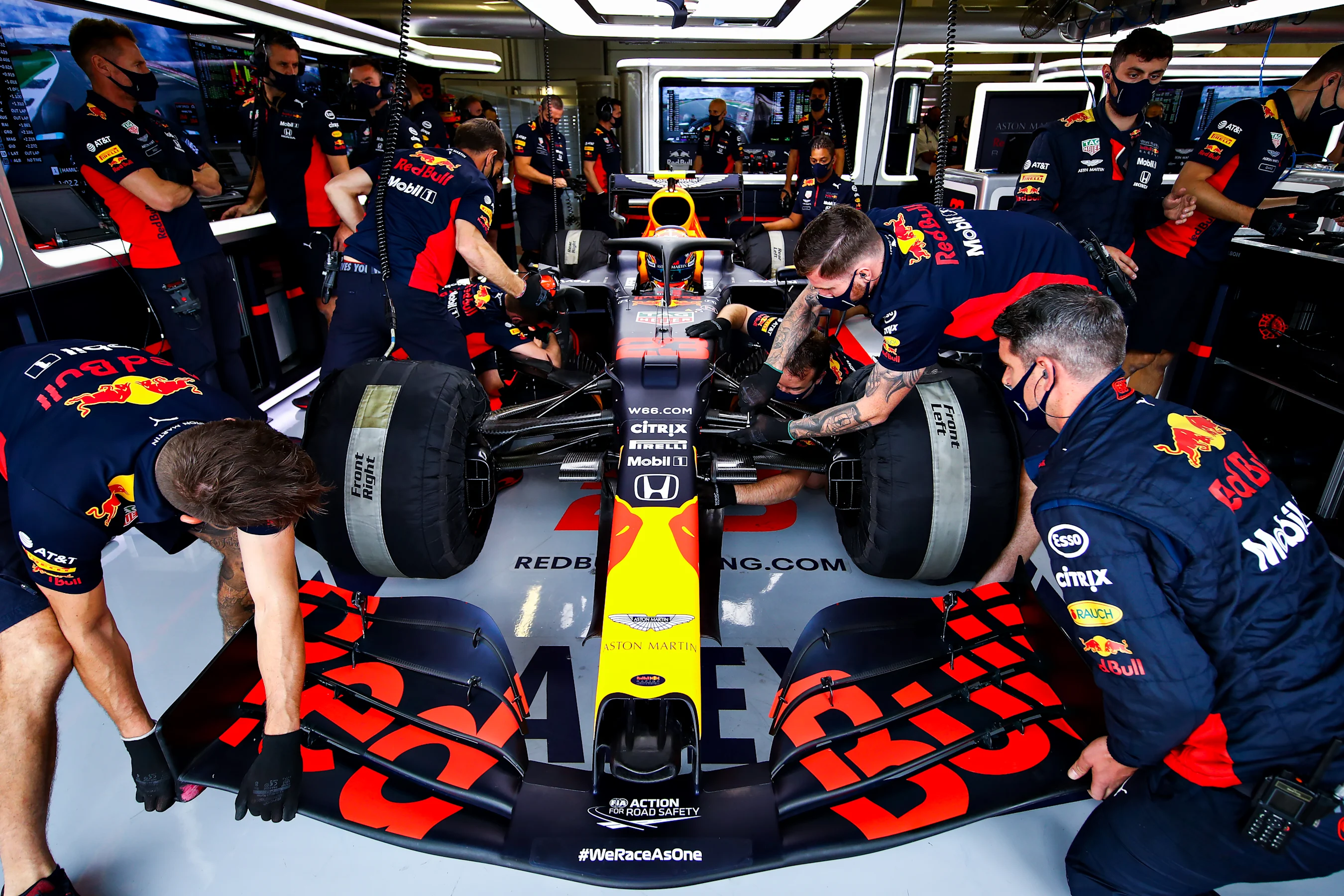 NORTHAMPTON, ENGLAND - AUGUST 01: The Red Bull Racing team work on the car of Alexander Albon of