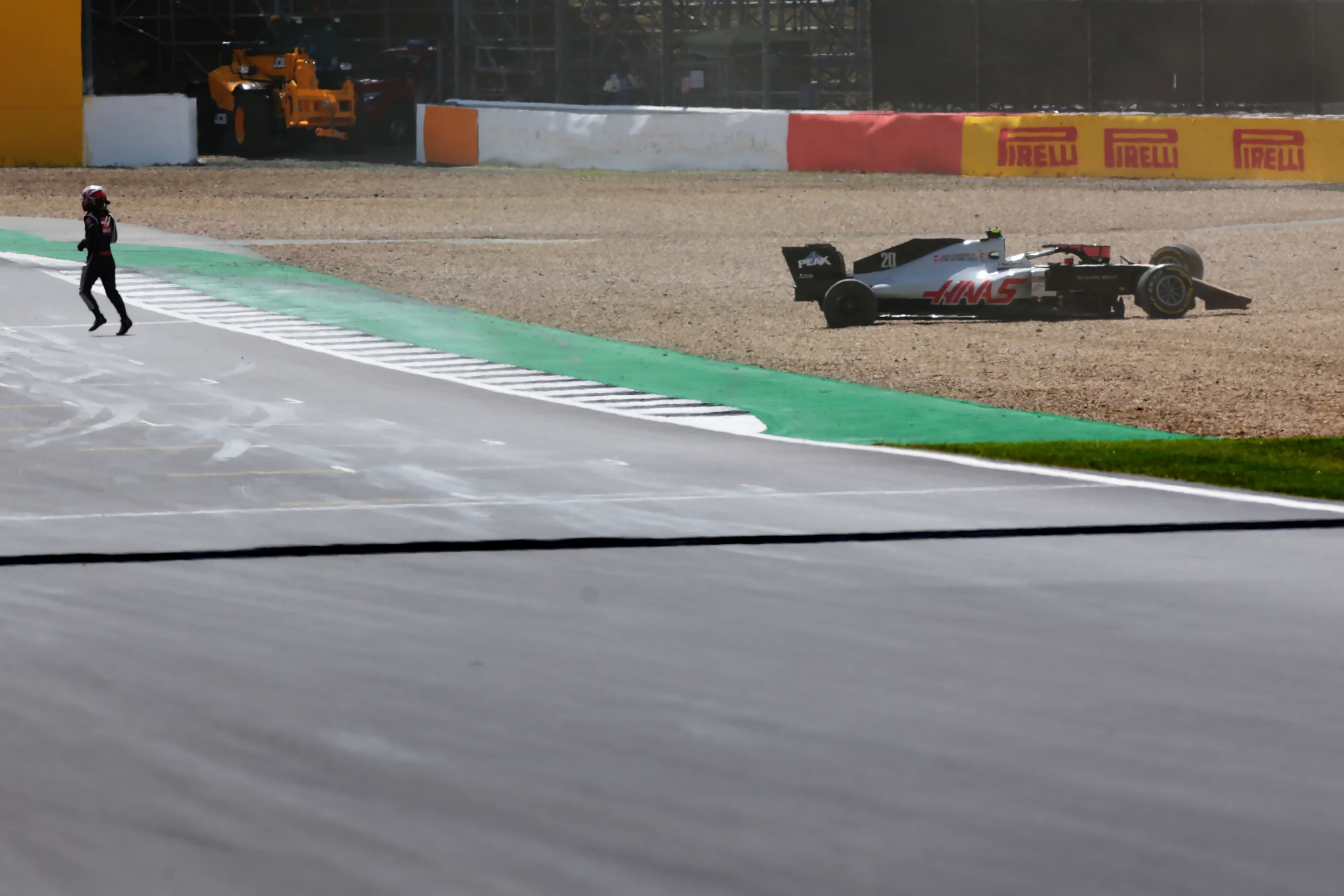 NORTHAMPTON, ENGLAND - AUGUST 02:Kevin Magnussen of Denmark and Haas F1 runs from his car after