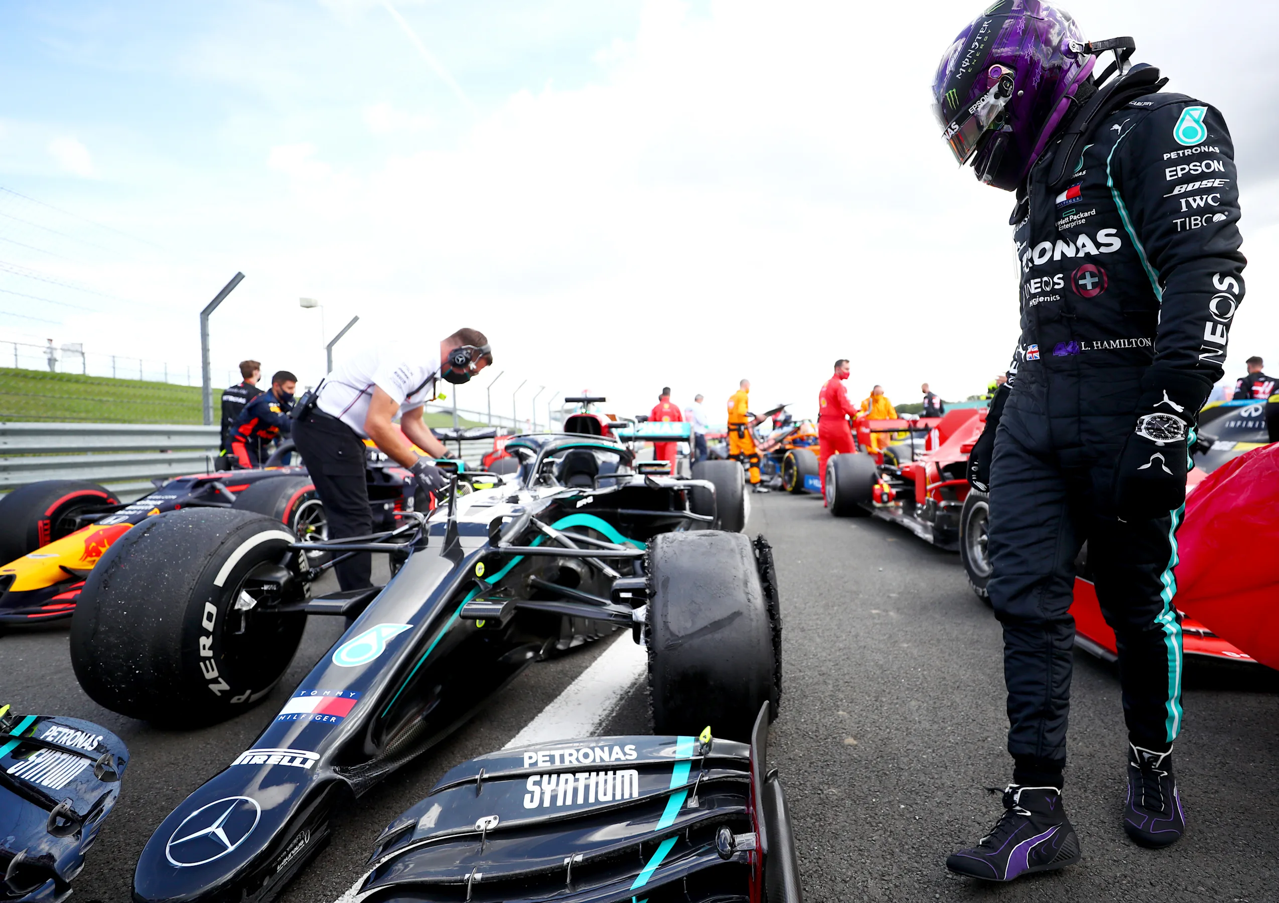 NORTHAMPTON, ENGLAND - AUGUST 02: Lewis Hamilton of Great Britain and Mercedes GP inspects his