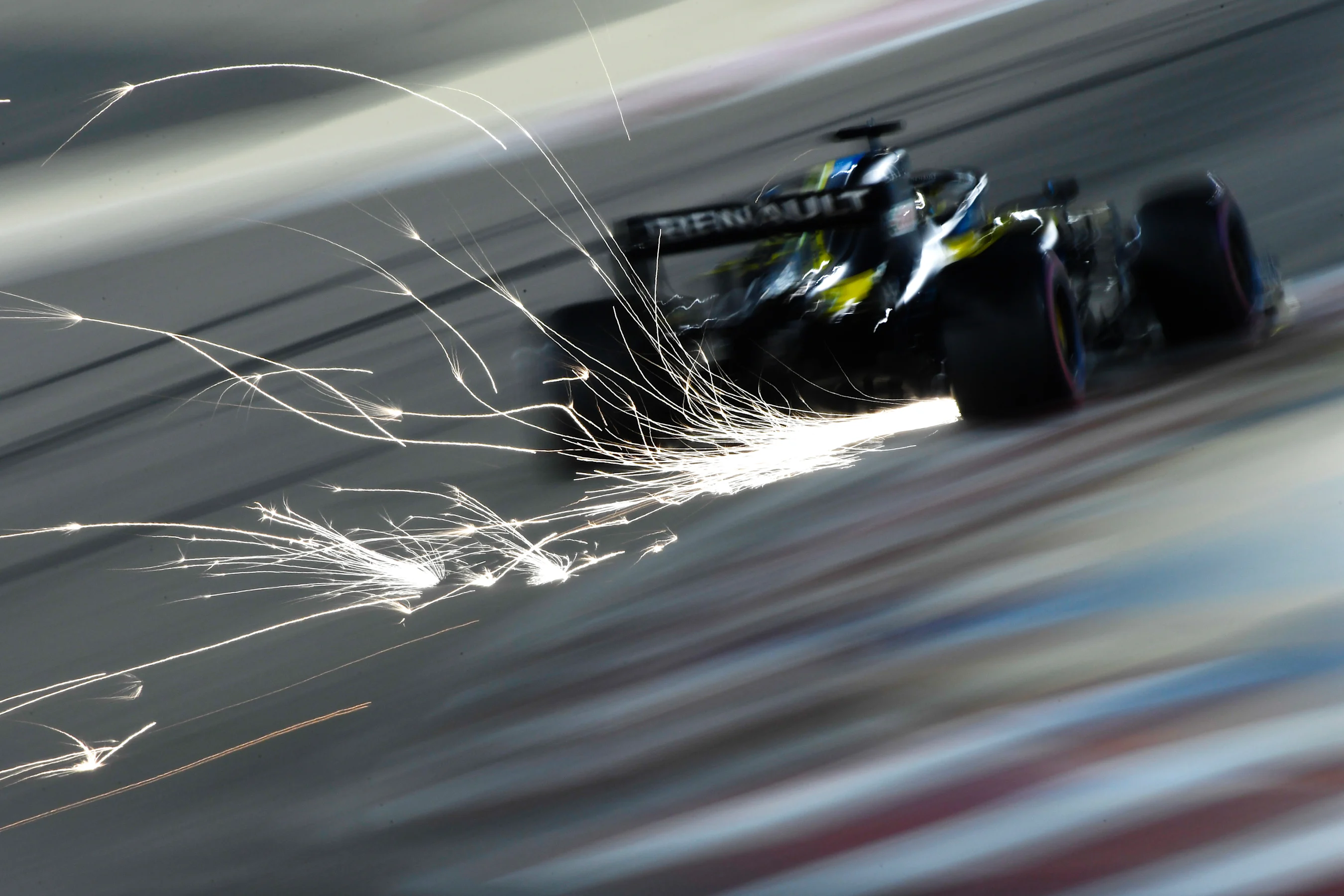 BAHRAIN, BAHRAIN - DECEMBER 05: Sparks fly behind Daniel Ricciardo of Australia driving the (3)