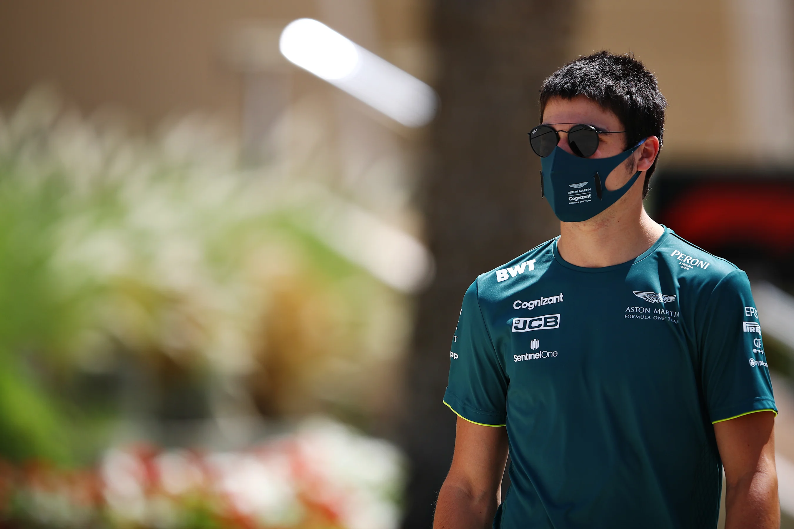 BAHRAIN, BAHRAIN - MARCH 27: Lance Stroll of Canada and Aston Martin F1 Team walks in the Paddock