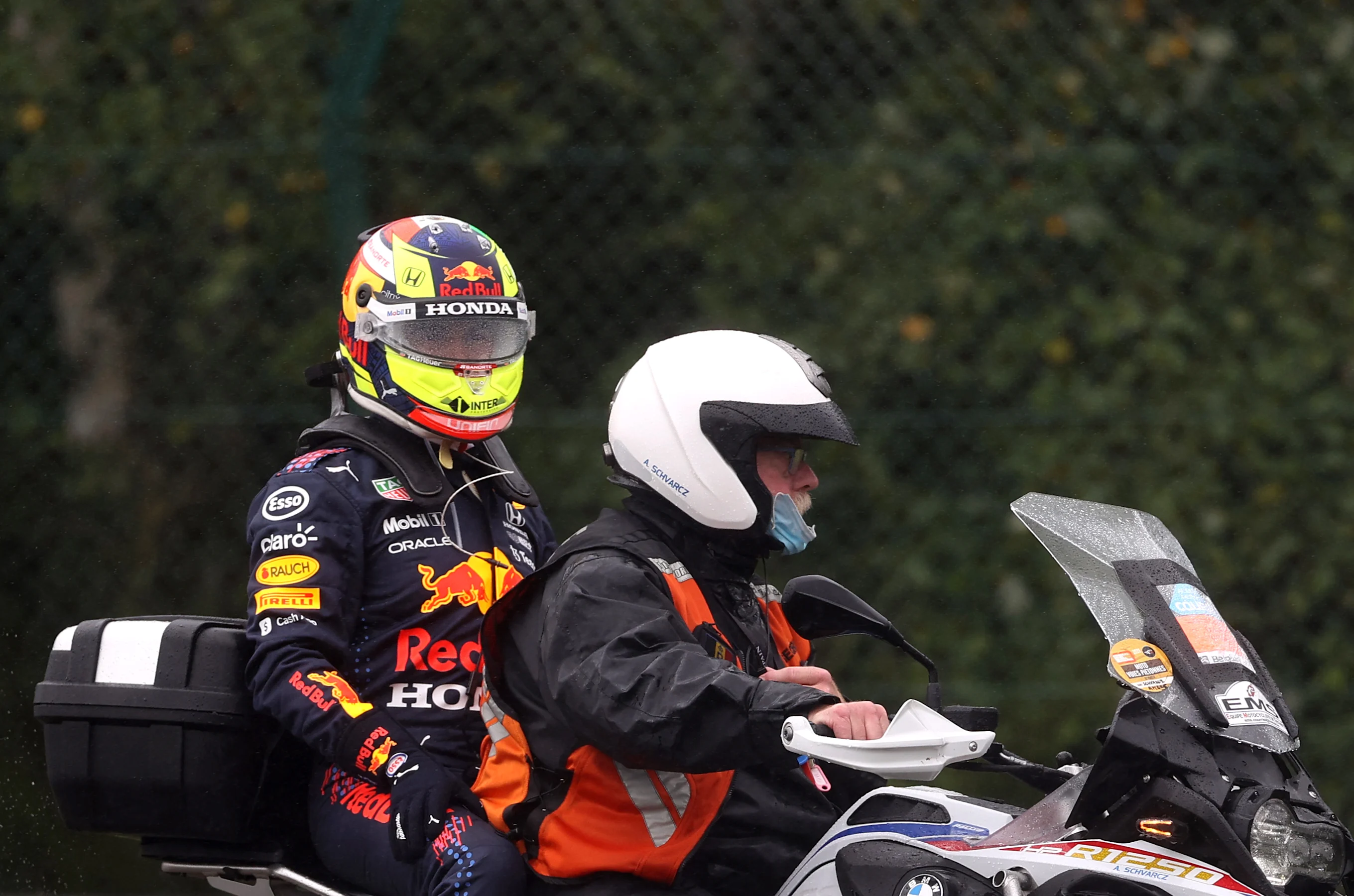 SPA, BELGIUM - AUGUST 29: Sergio Perez of Mexico and Red Bull Racing is given a lift back to the