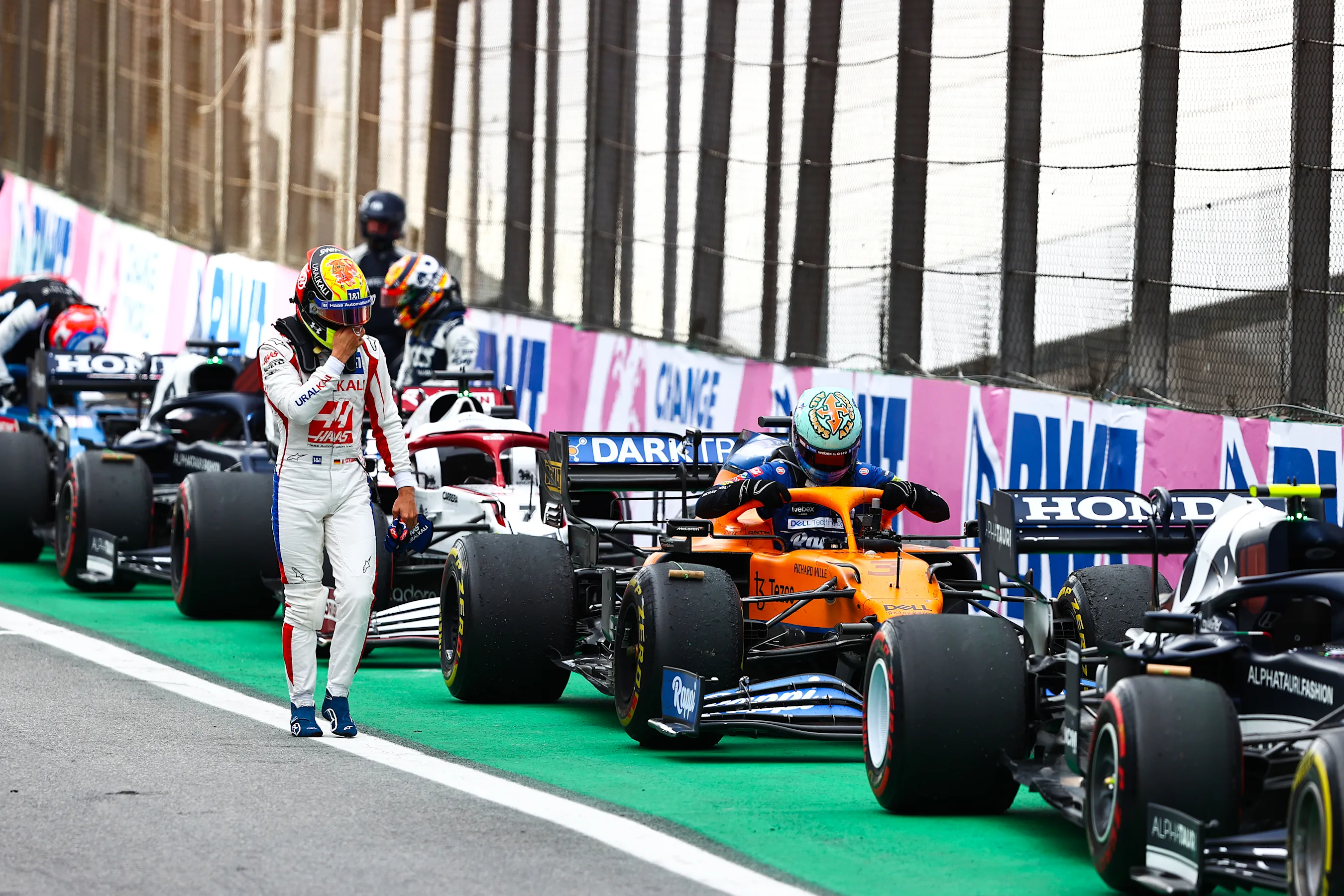 SAO PAULO, BRAZIL - NOVEMBER 13: Mick Schumacher of Germany and Haas F1 walks past Daniel Ricciardo