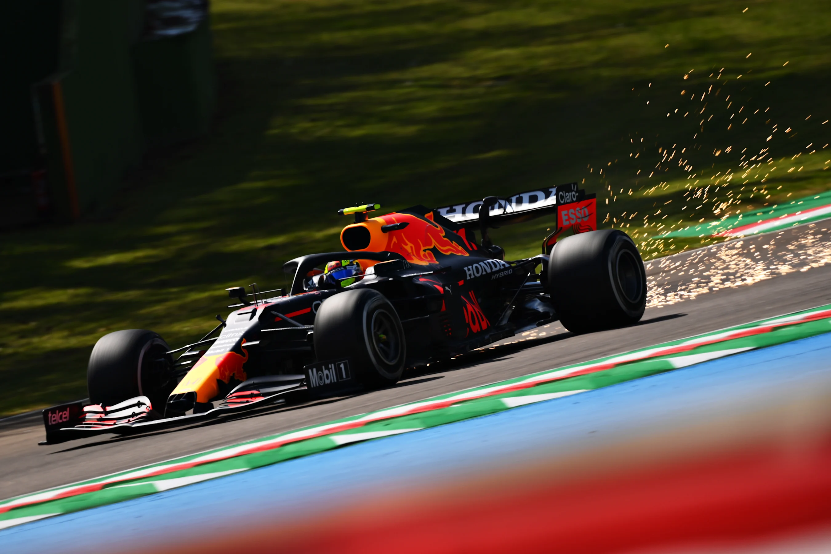 IMOLA, ITALY - APRIL 16: Sparks fly behind Sergio Perez of Mexico driving the (11) Red Bull Racing