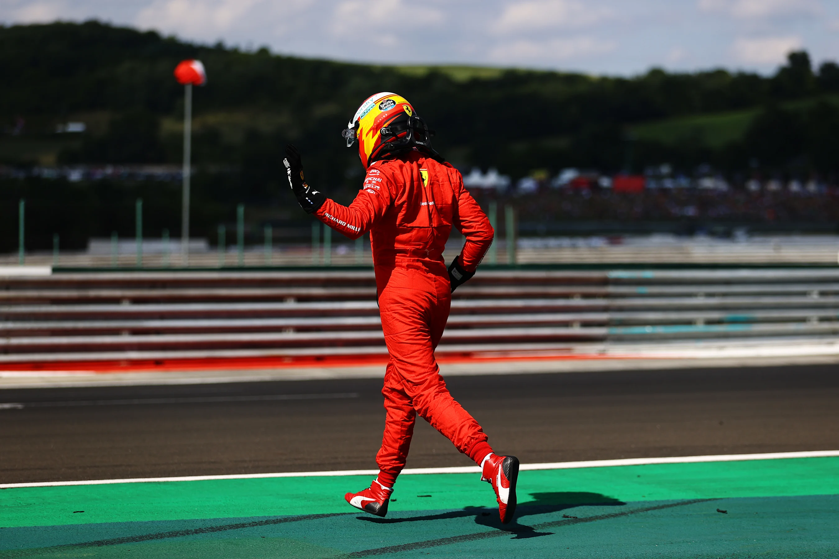BUDAPEST, HUNGARY - JULY 31: Carlos Sainz of Spain driving the (55) Scuderia Ferrari SF21 walks