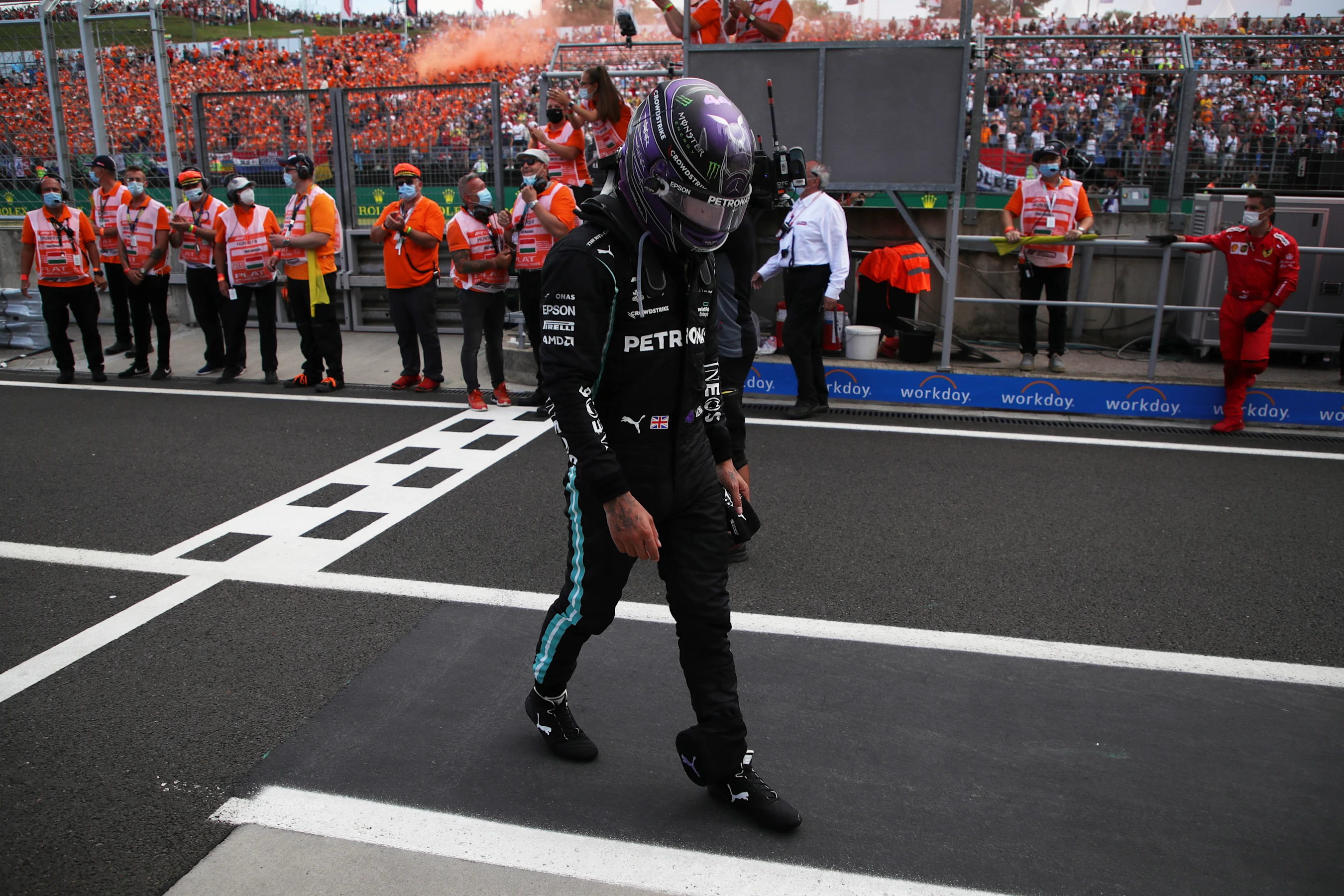 BUDAPEST, HUNGARY - AUGUST 01: Third placed Lewis Hamilton of Great Britain and Mercedes GP walks
