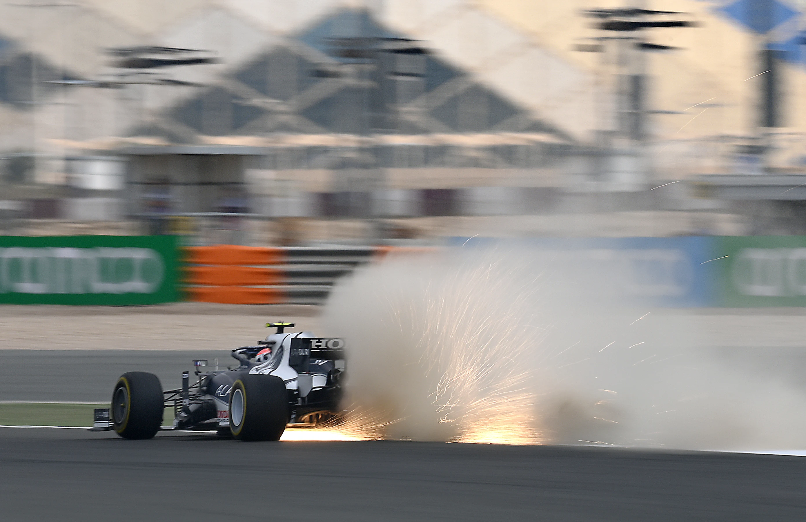 DOHA, QATAR - NOVEMBER 19: Sparks fly behind Pierre Gasly of France driving the (10) Scuderia