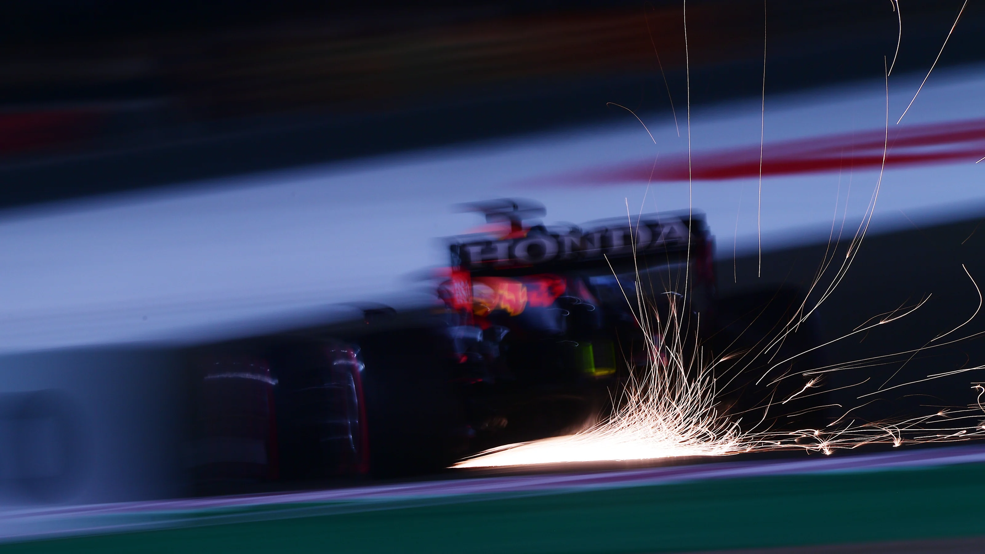 DOHA, QATAR - NOVEMBER 19: Sparks fly behind Max Verstappen of the Netherlands driving the (33) Red