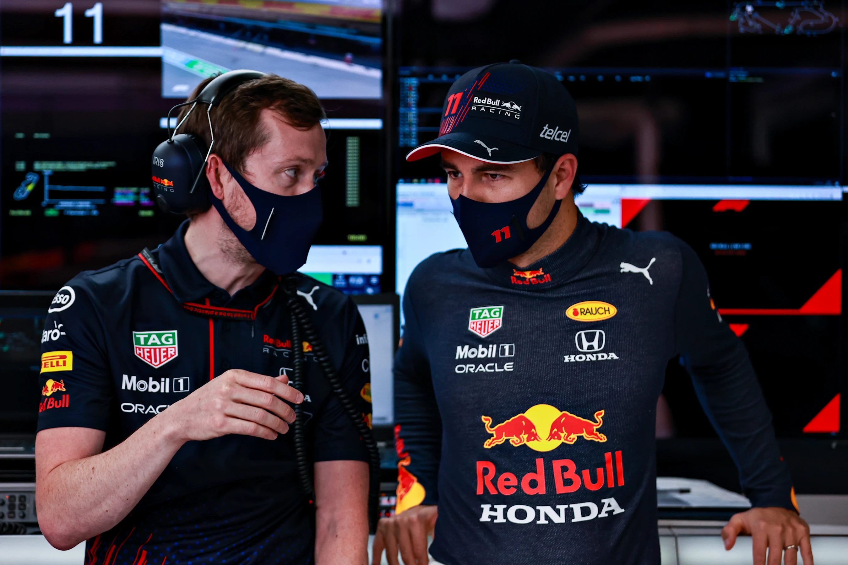 BARCELONA, SPAIN - MAY 08: Sergio Perez of Mexico and Red Bull Racing talks with an engineer in the