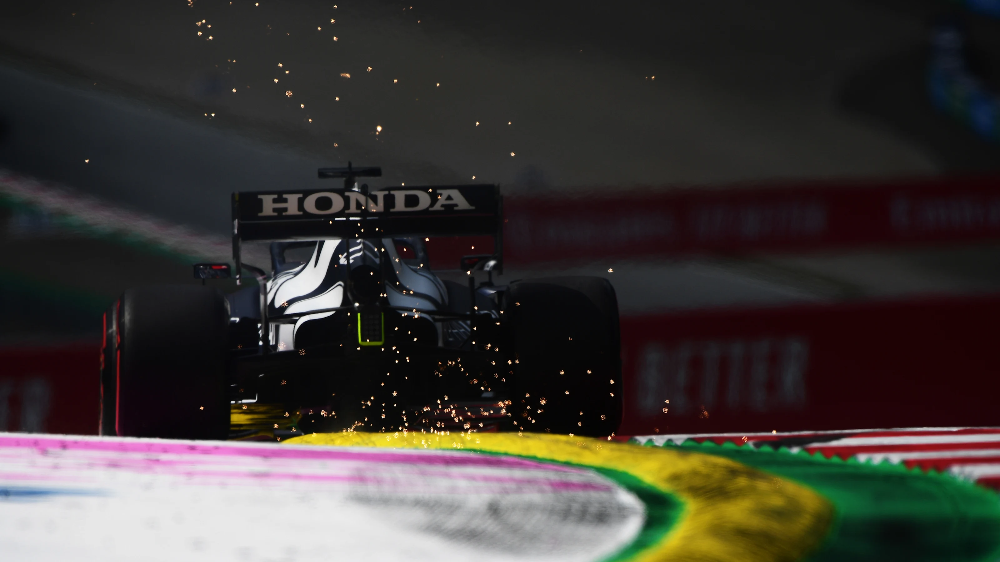 SPIELBERG, AUSTRIA - JUNE 25: Sparks fly behind Yuki Tsunoda of Japan driving the (22) Scuderia