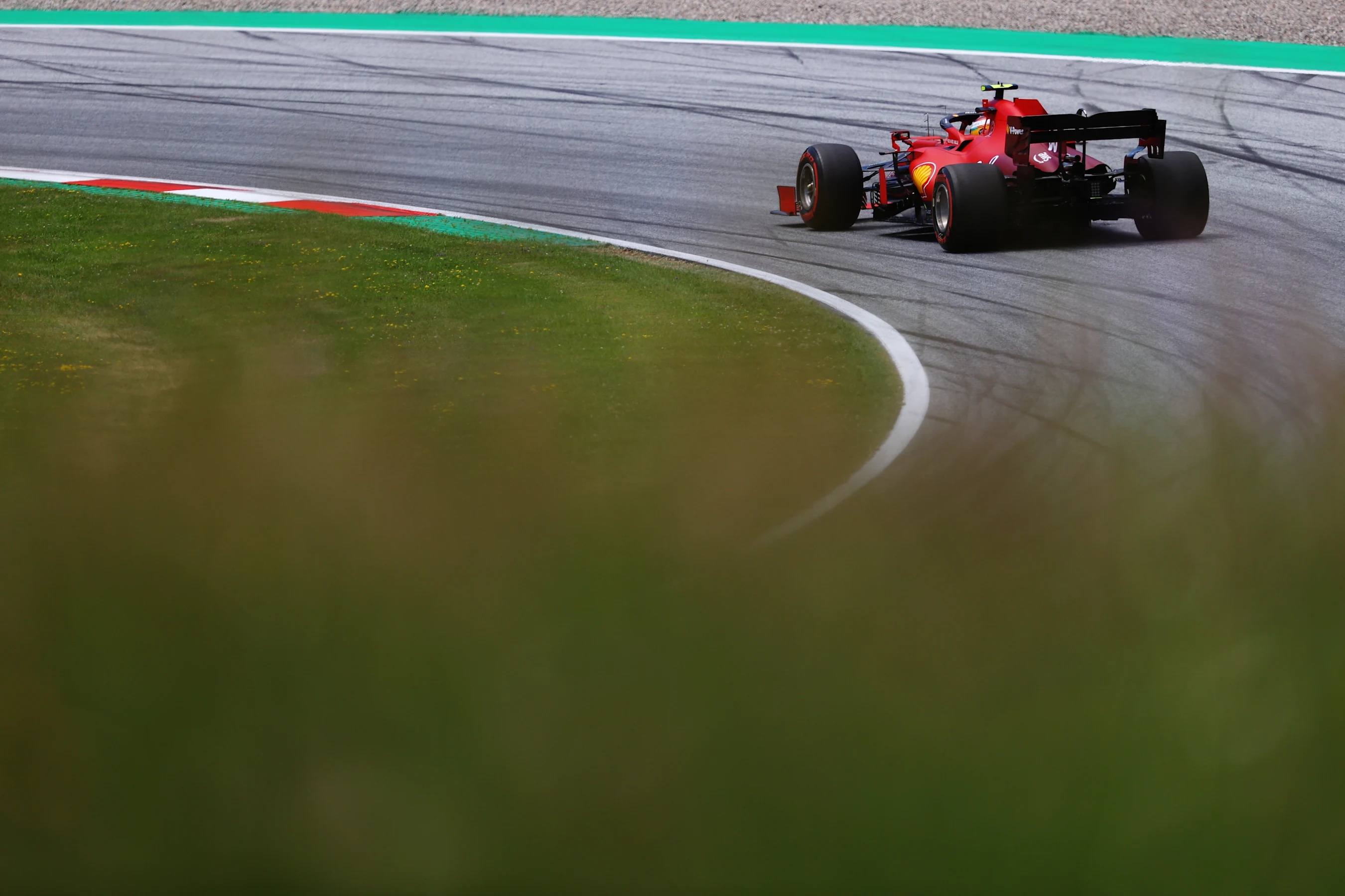 SPIELBERG, AUSTRIA - JUNE 26: Carlos Sainz of Spain driving the (55) Scuderia Ferrari SF21 on track