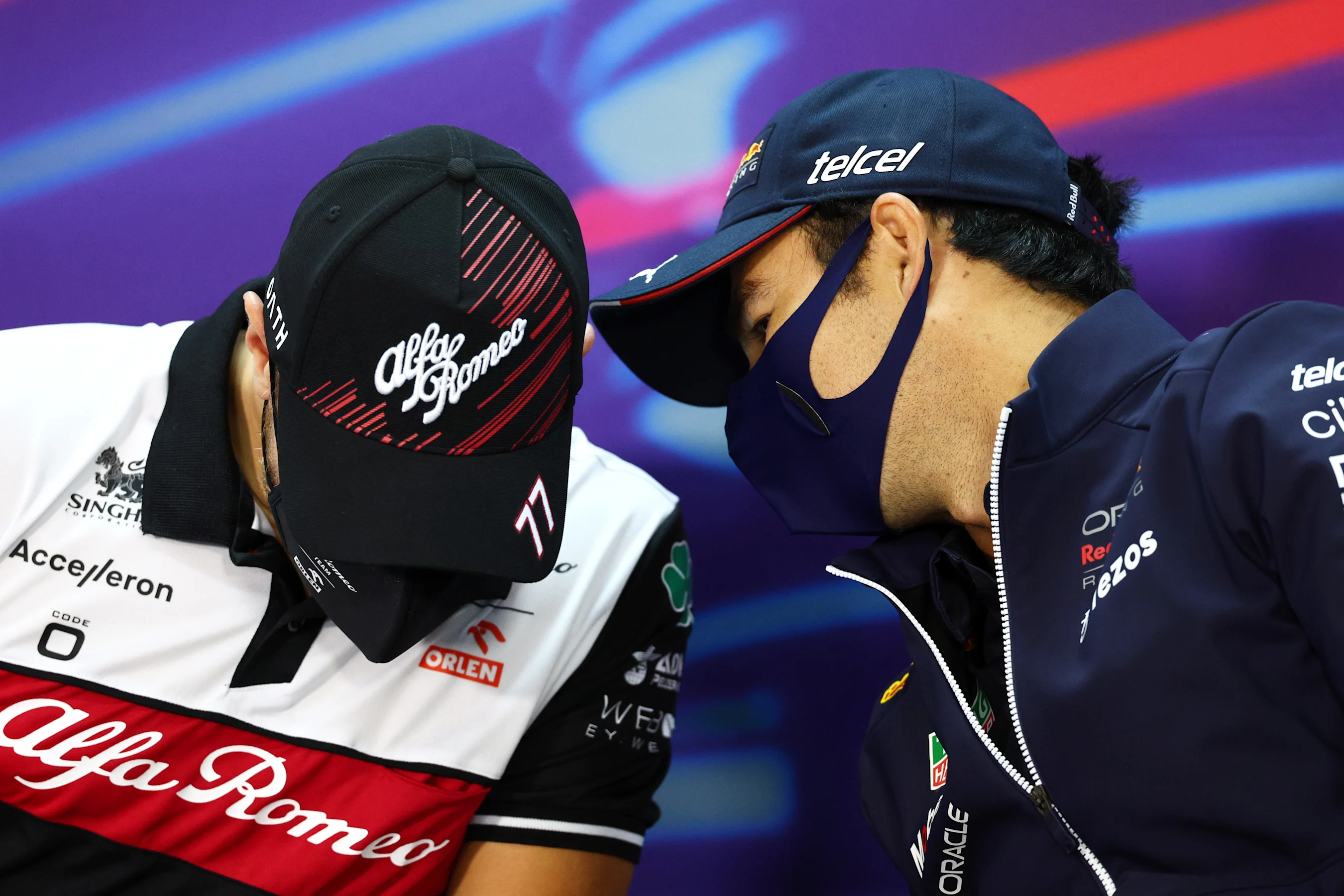 BAHRAIN, BAHRAIN - MARCH 18: Sergio Perez of Mexico and Oracle Red Bull Racing talks with Valtteri