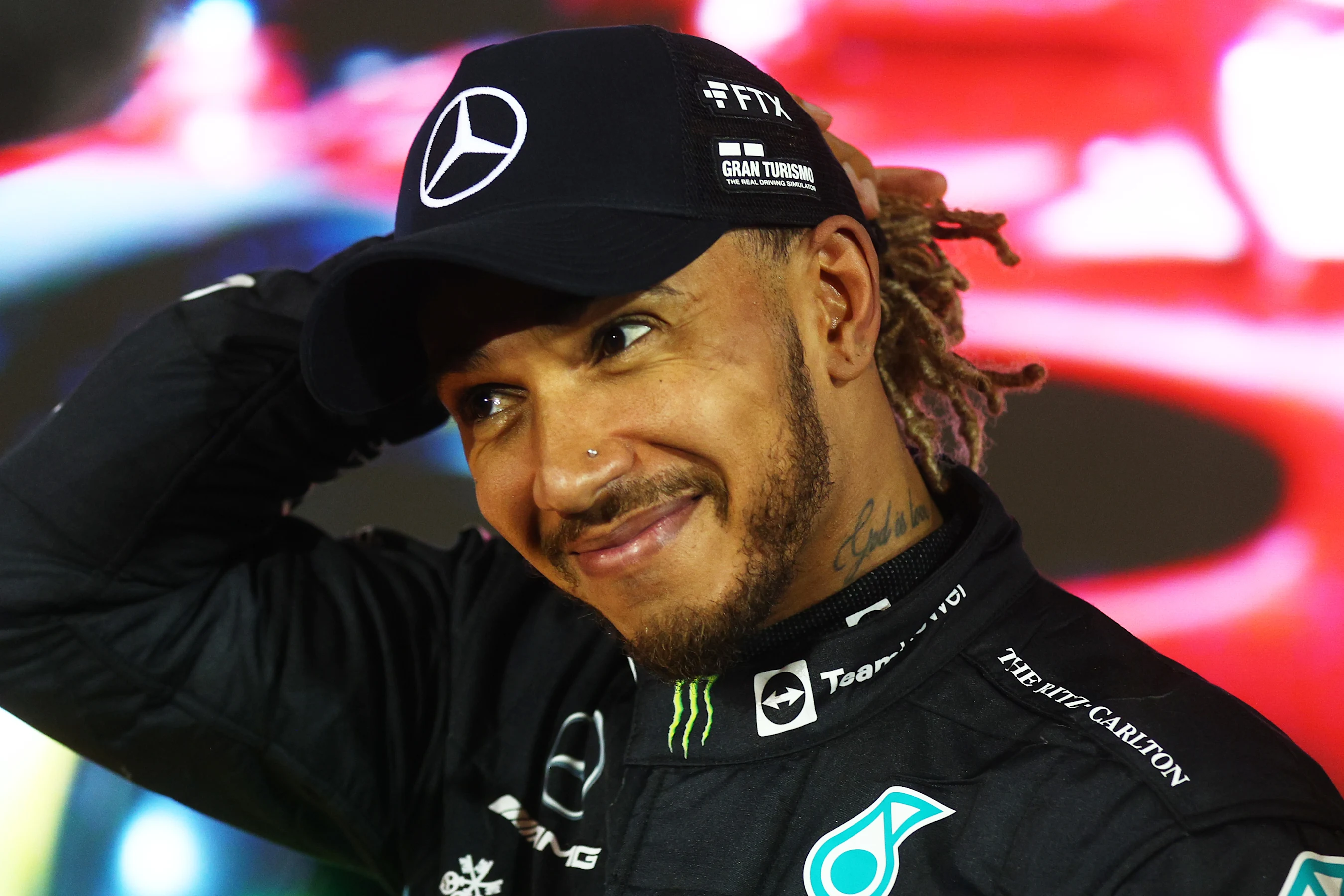 BAHRAIN, BAHRAIN - MARCH 20: Third placed Lewis Hamilton of Great Britain and Mercedes looks on in