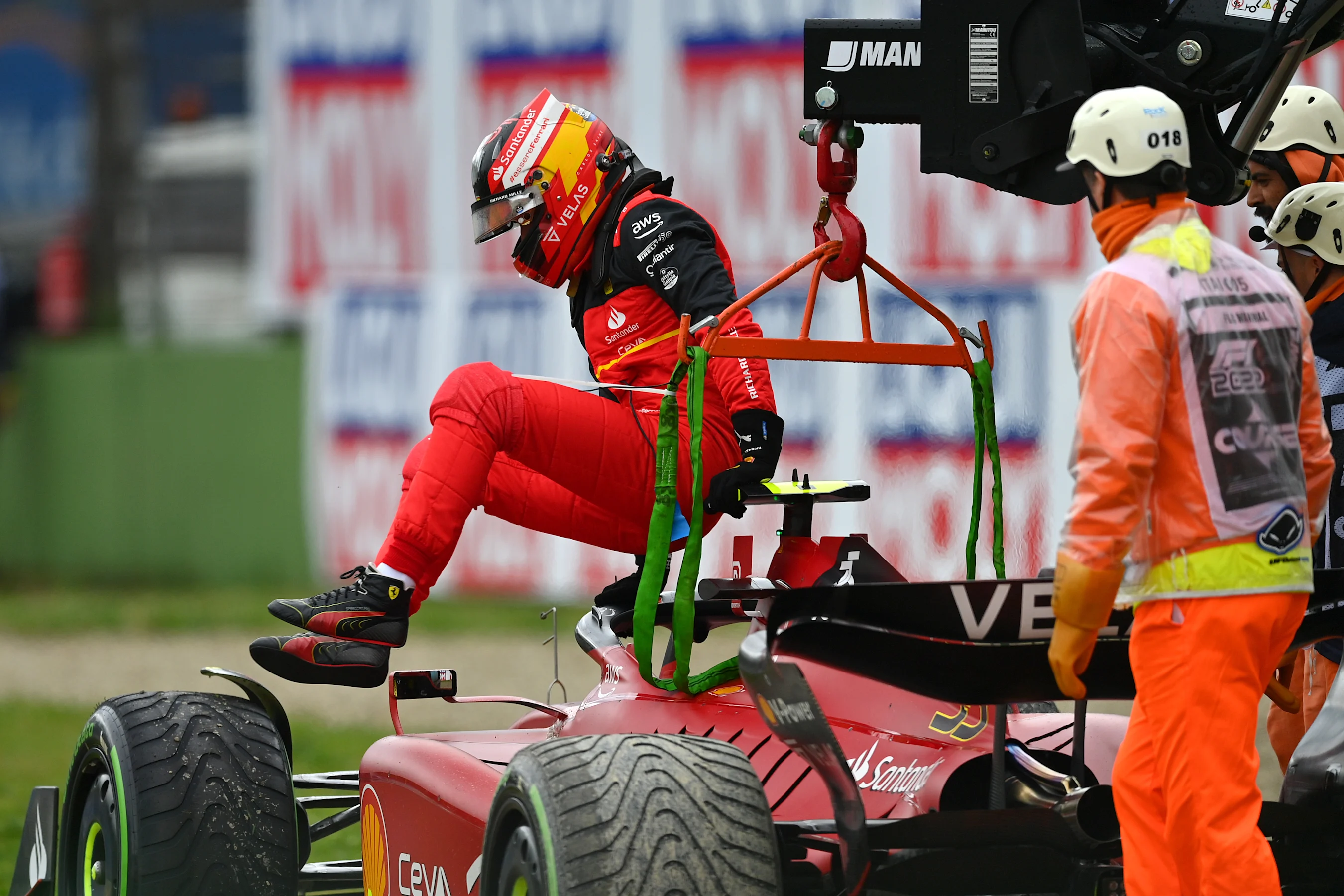 IMOLA, ITALY - APRIL 24: Carlos Sainz of Spain and Ferrari climbs from his car after retiring from