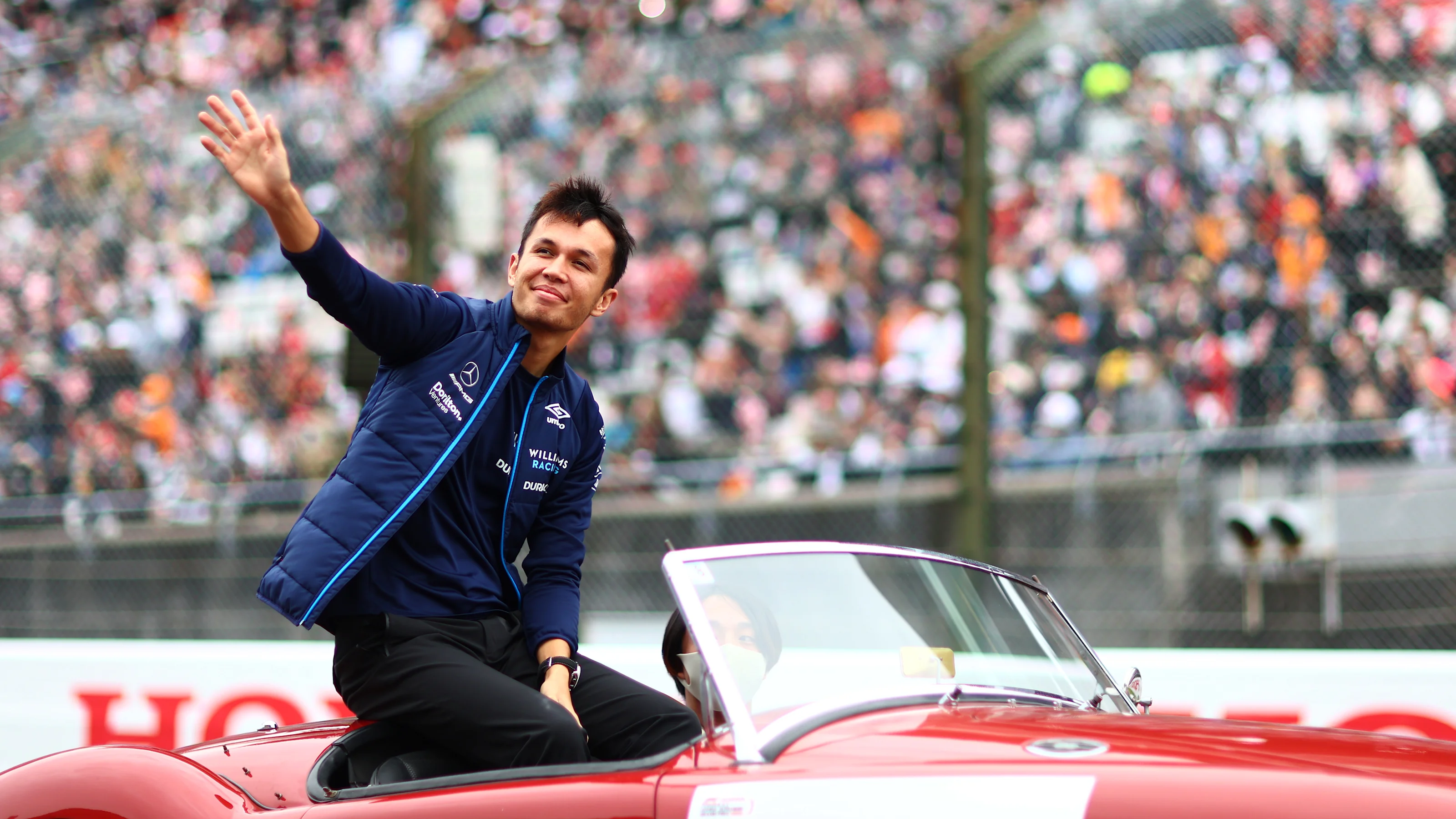 SUZUKA, JAPAN - OCTOBER 09: Alexander Albon of Thailand and Williams waves to the crowd on the