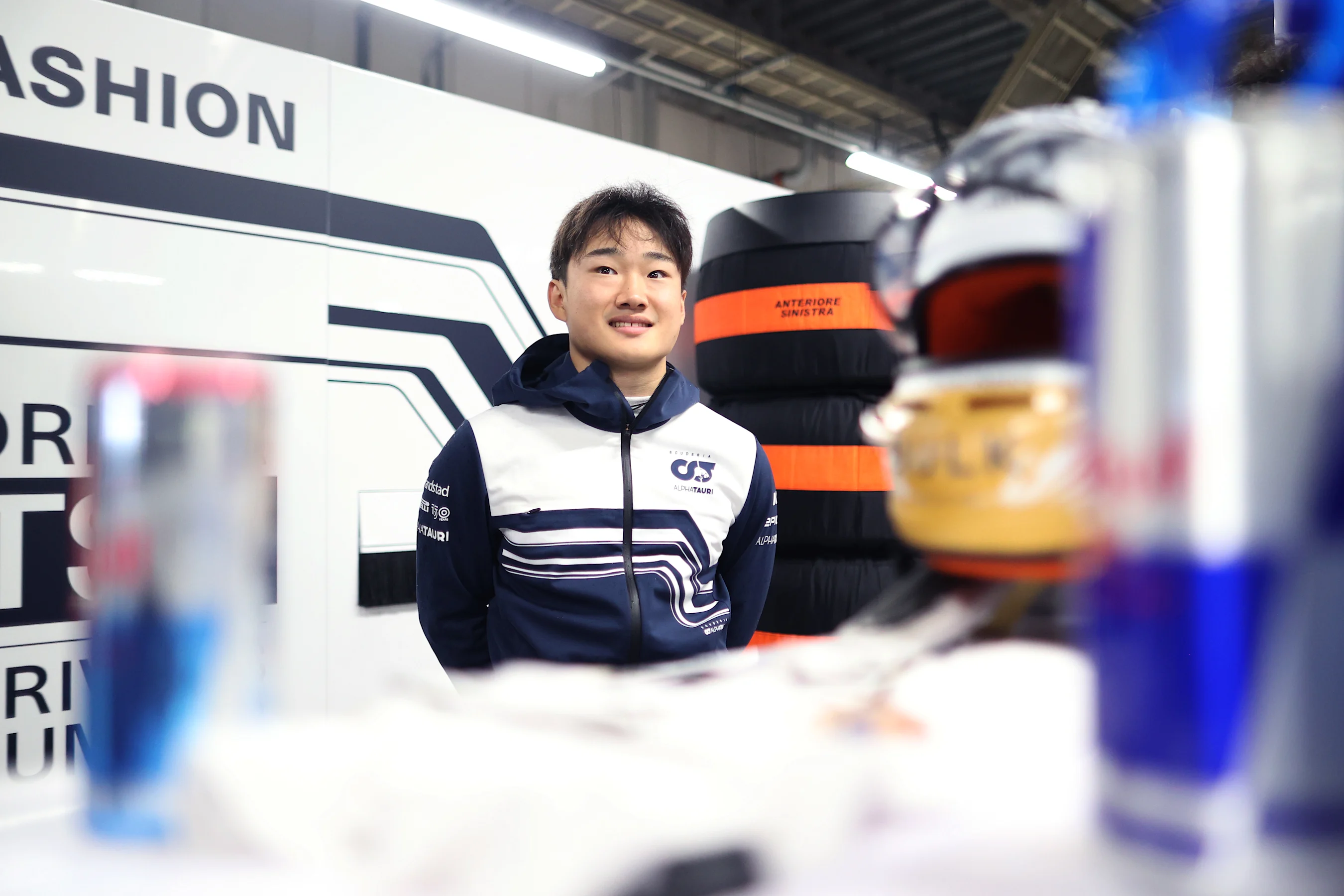 SUZUKA, JAPAN - OCTOBER 09: Yuki Tsunoda of Japan and Scuderia AlphaTauri looks on in the garage