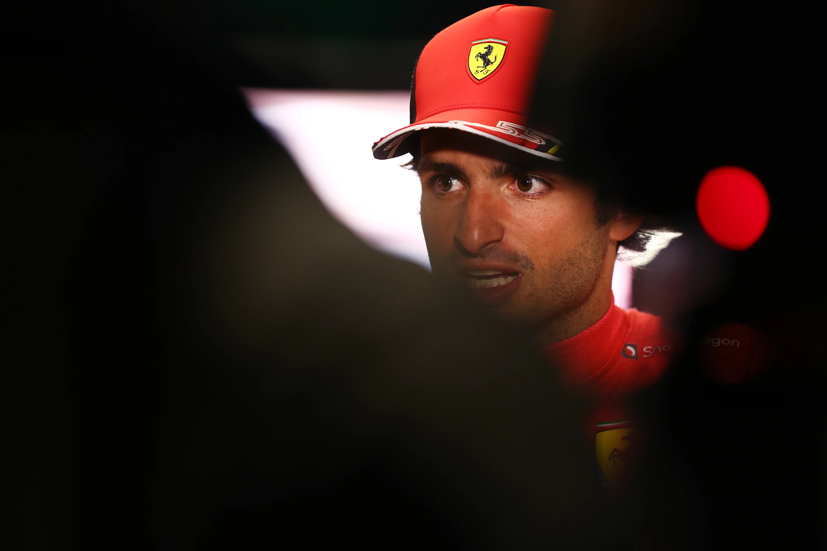 JEDDAH, SAUDI ARABIA - MARCH 26: Third placed qualifier Carlos Sainz of Spain and Ferrari talks to