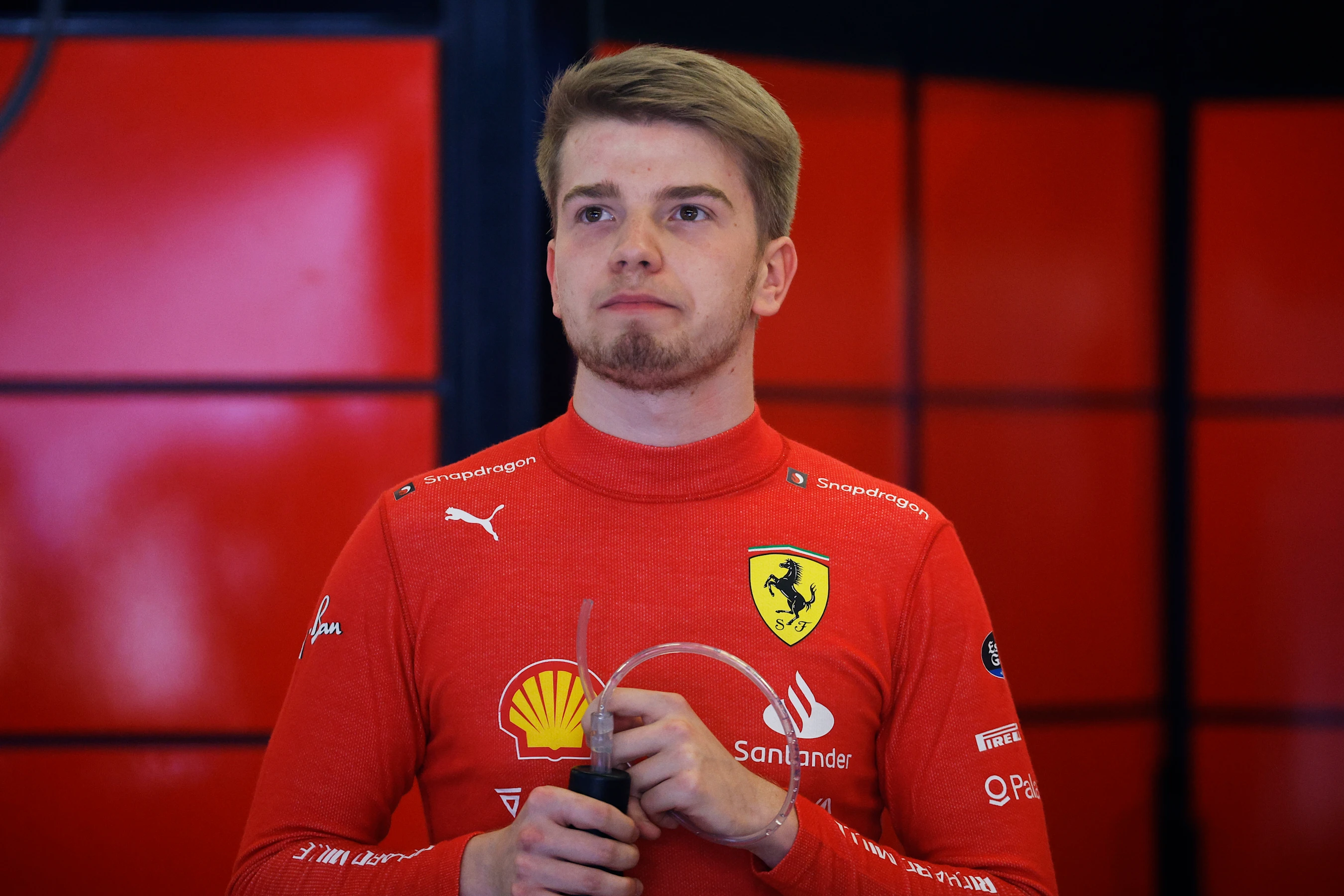 AUSTIN, TEXAS - OCTOBER 21: Robert Shwartzman of Israel and Ferrari looks on from the garage during