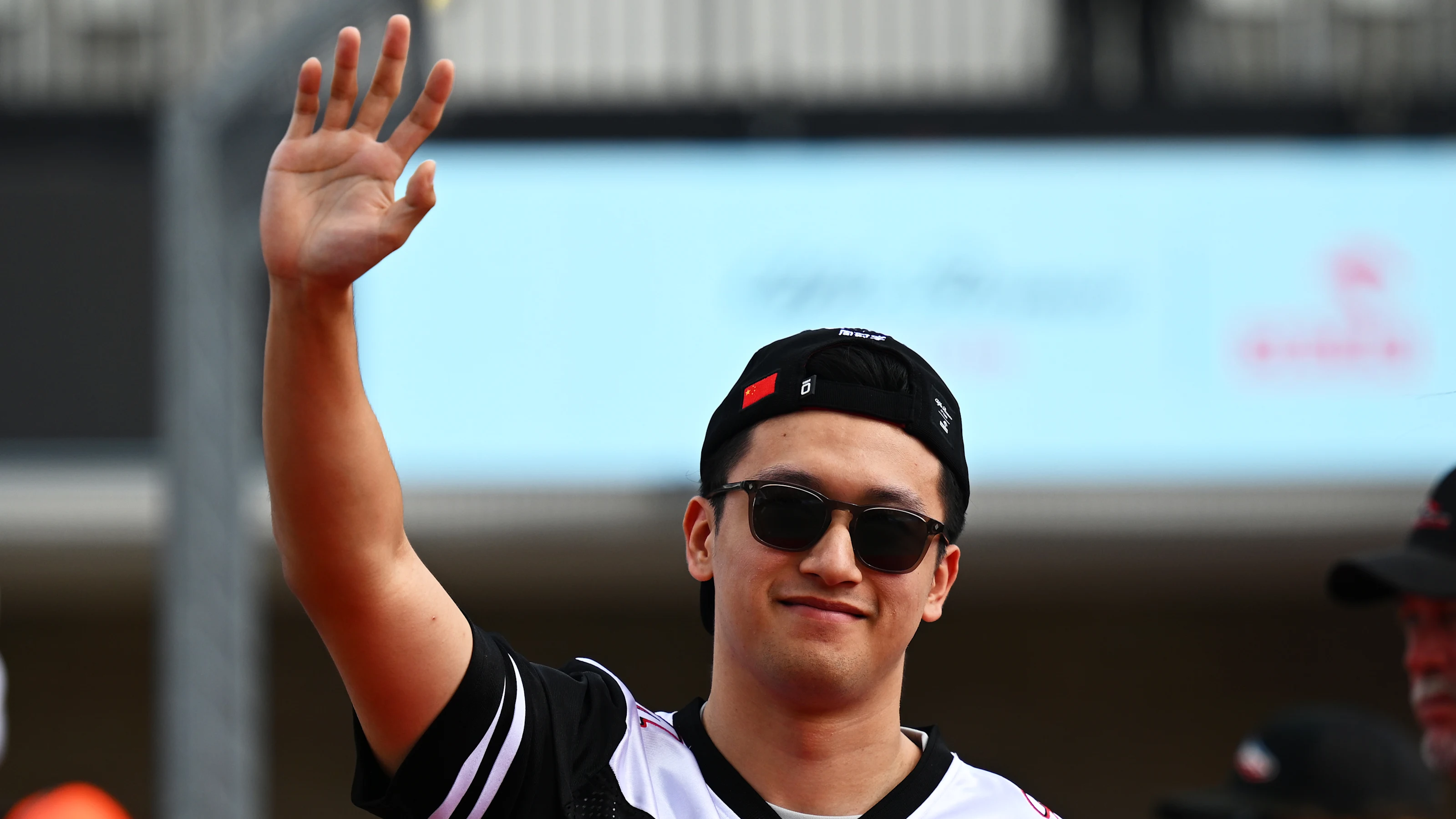 AUSTIN, TEXAS - OCTOBER 23: Zhou Guanyu of China and Alfa Romeo F1 waves to the crowd on the