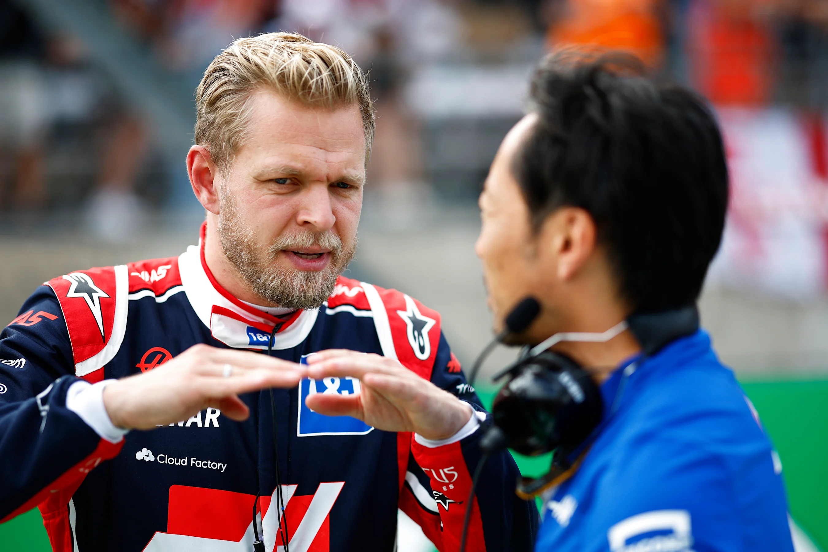 AUSTIN, TEXAS - OCTOBER 23: Kevin Magnussen of Denmark and Haas F1 talks with Ayao Komatsu on the