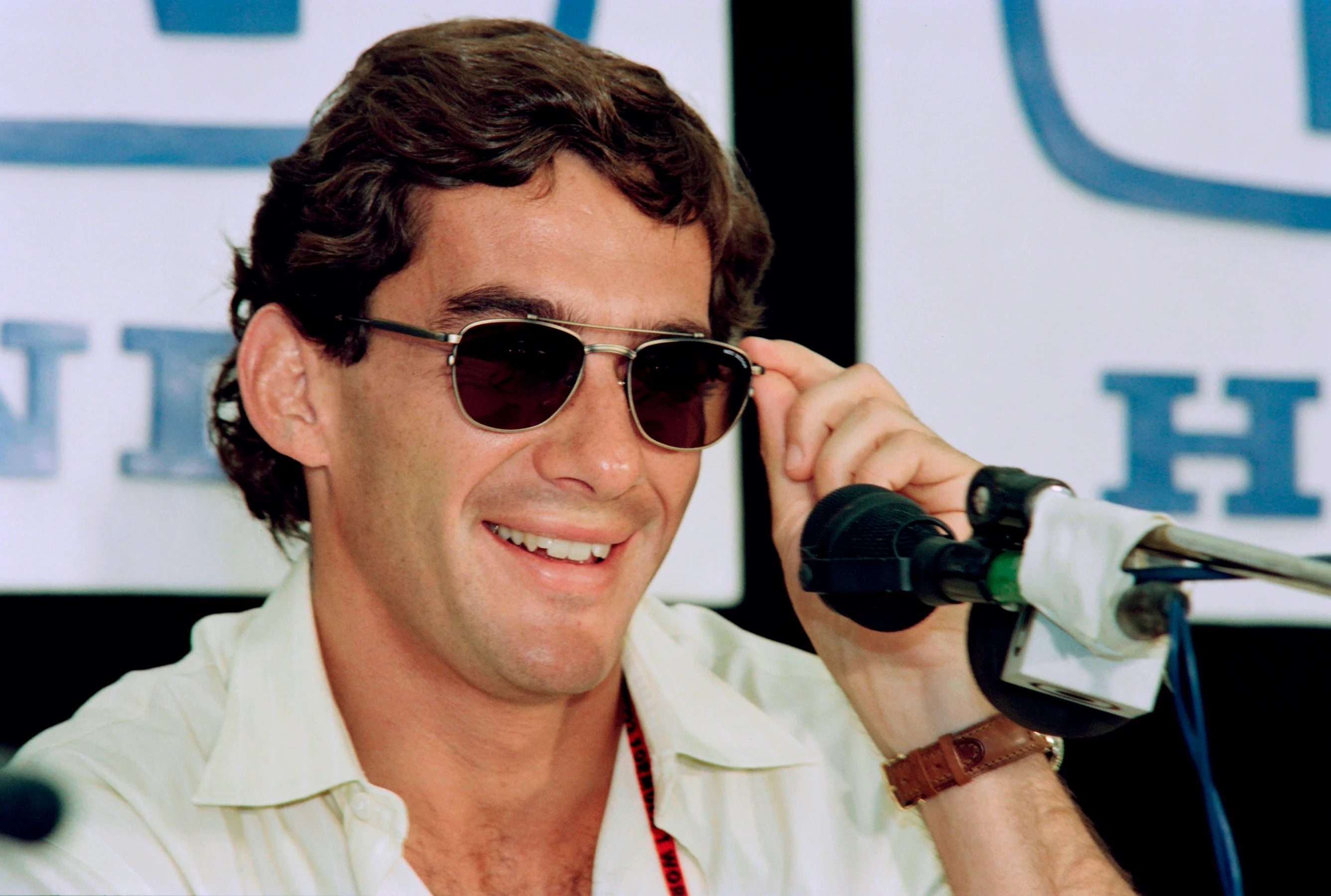 Brazilian Formula One driver Ayrton Senna smiles as he answers newsmen questions during a press
