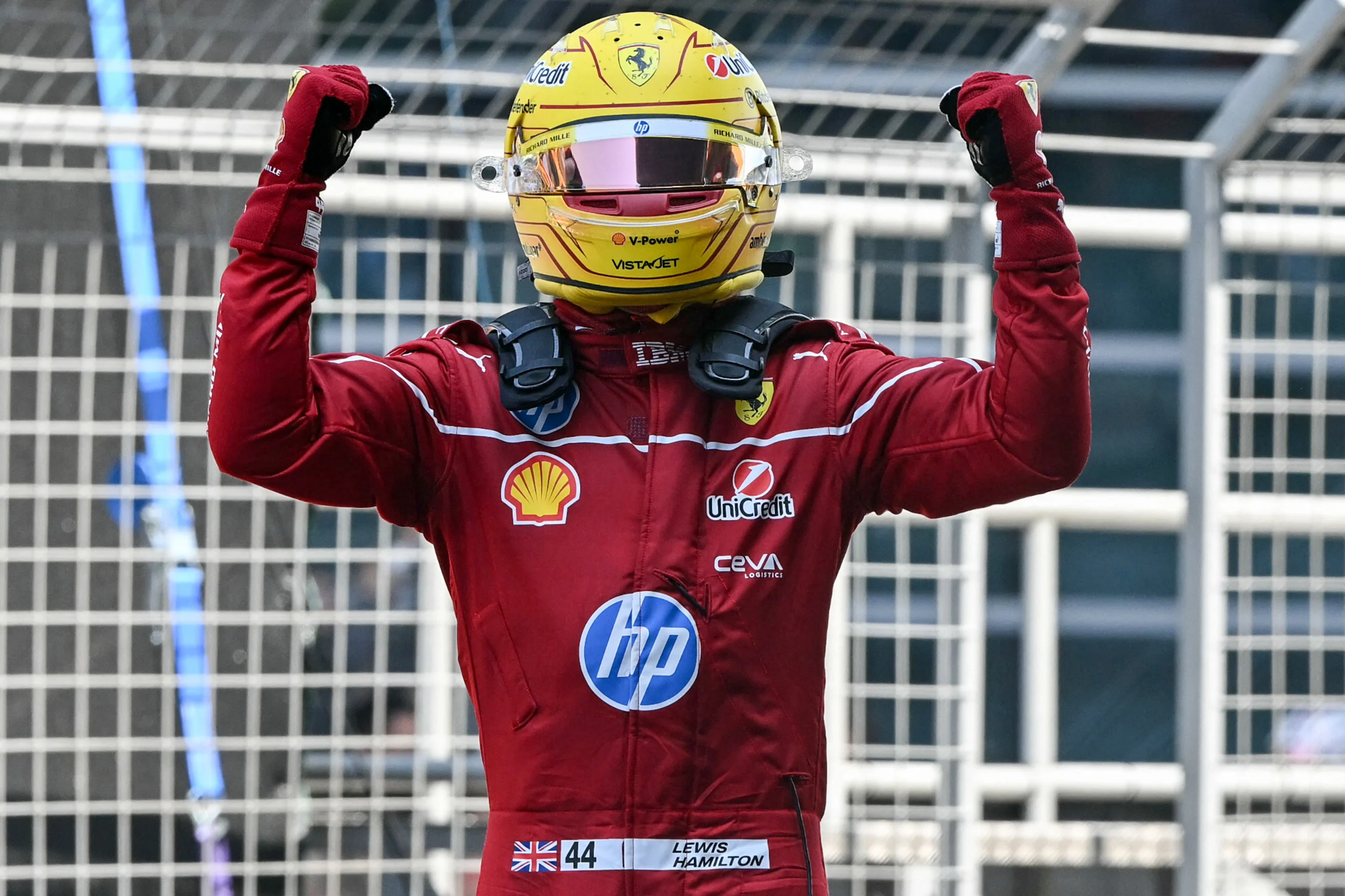 TOPSHOT - Ferrari's British driver Lewis Hamilton celebrates winning the sprint race of the Formula
