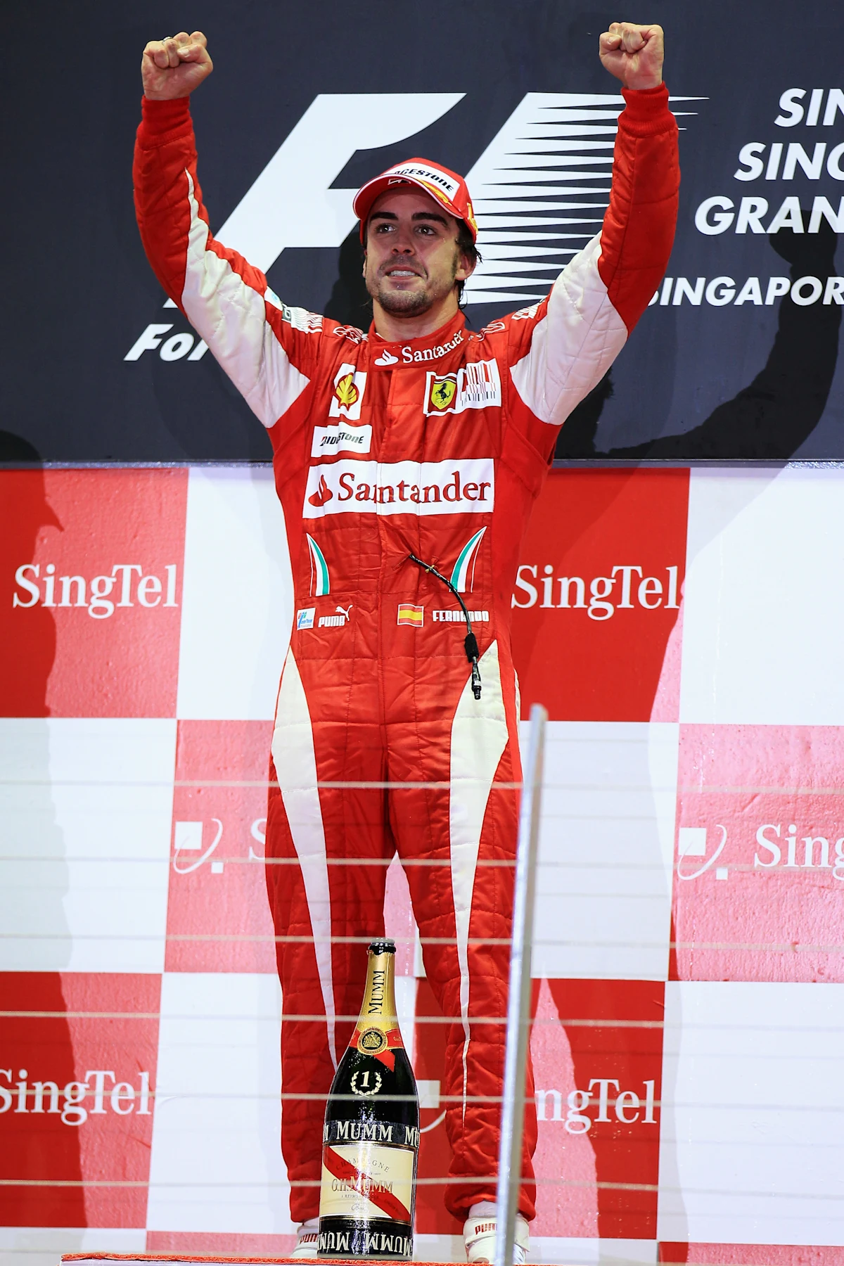 SINGAPORE - SEPTEMBER 26:  Fernando Alonso of Spain and Ferrari celebrates on the podium after